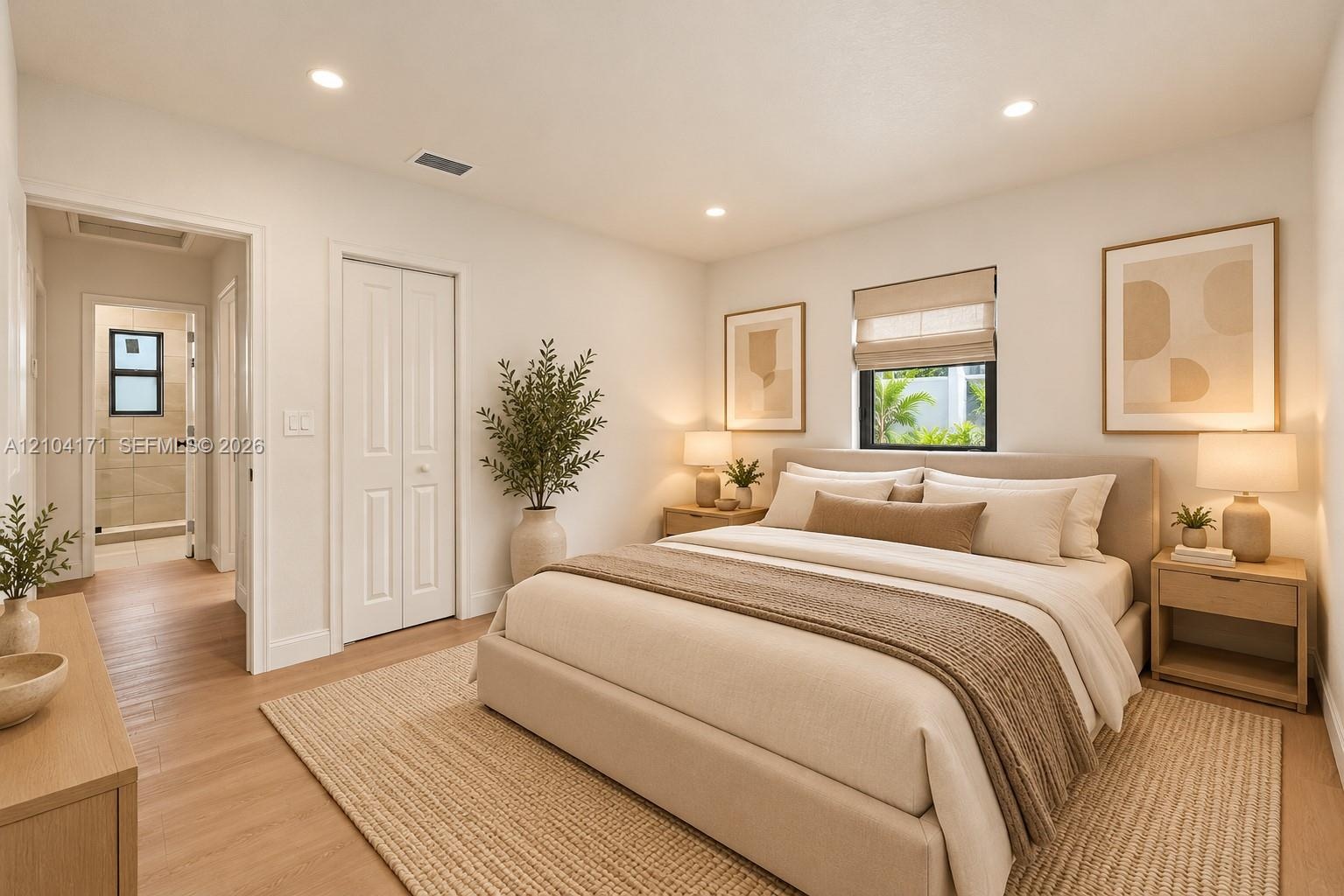 Neutral-toned interior featuring recessed lighting, wood-finish flooring, and a window with a roller shade