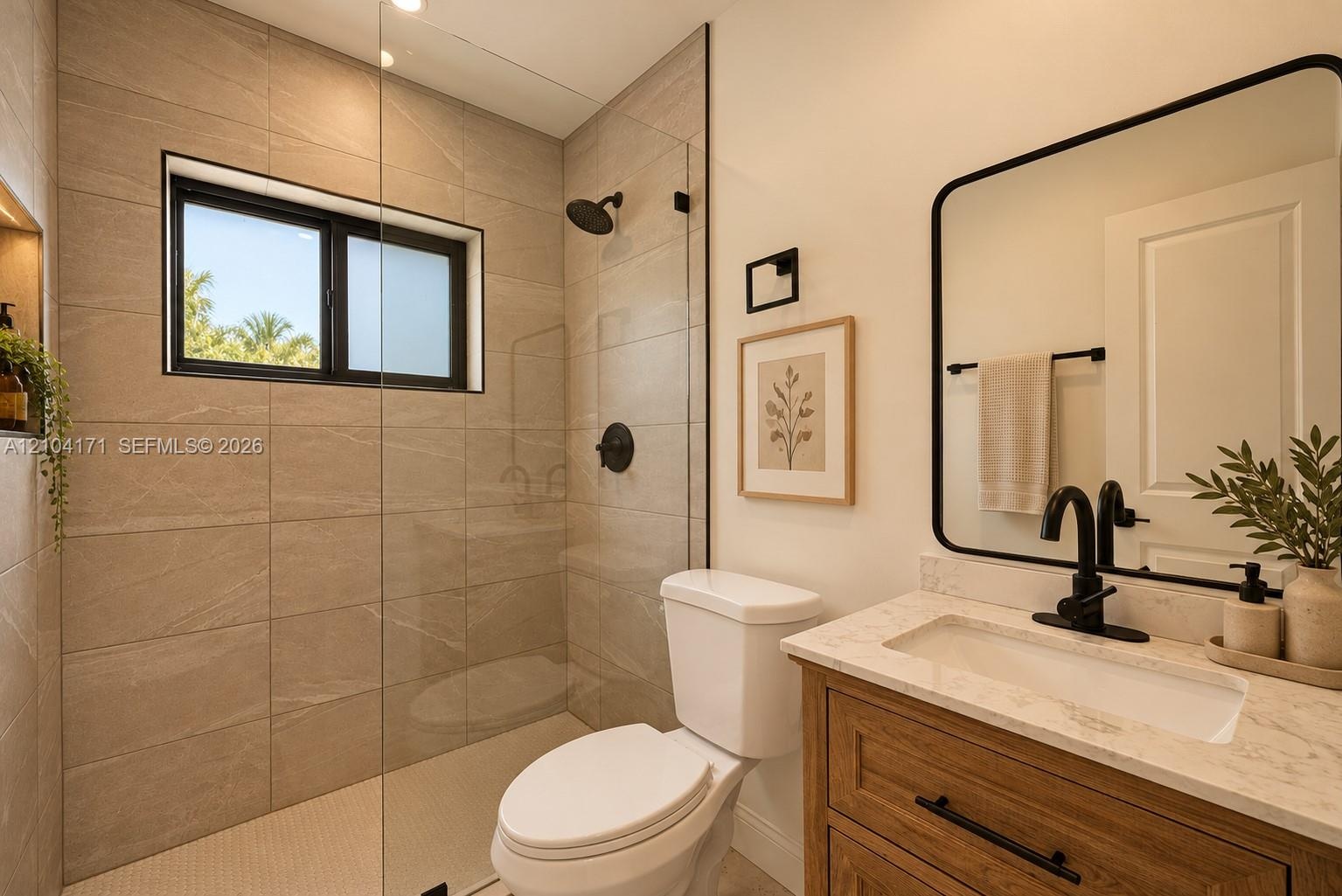 Neutral interior featuring recessed lighting, a window with woven shade, and solid-surface flooring