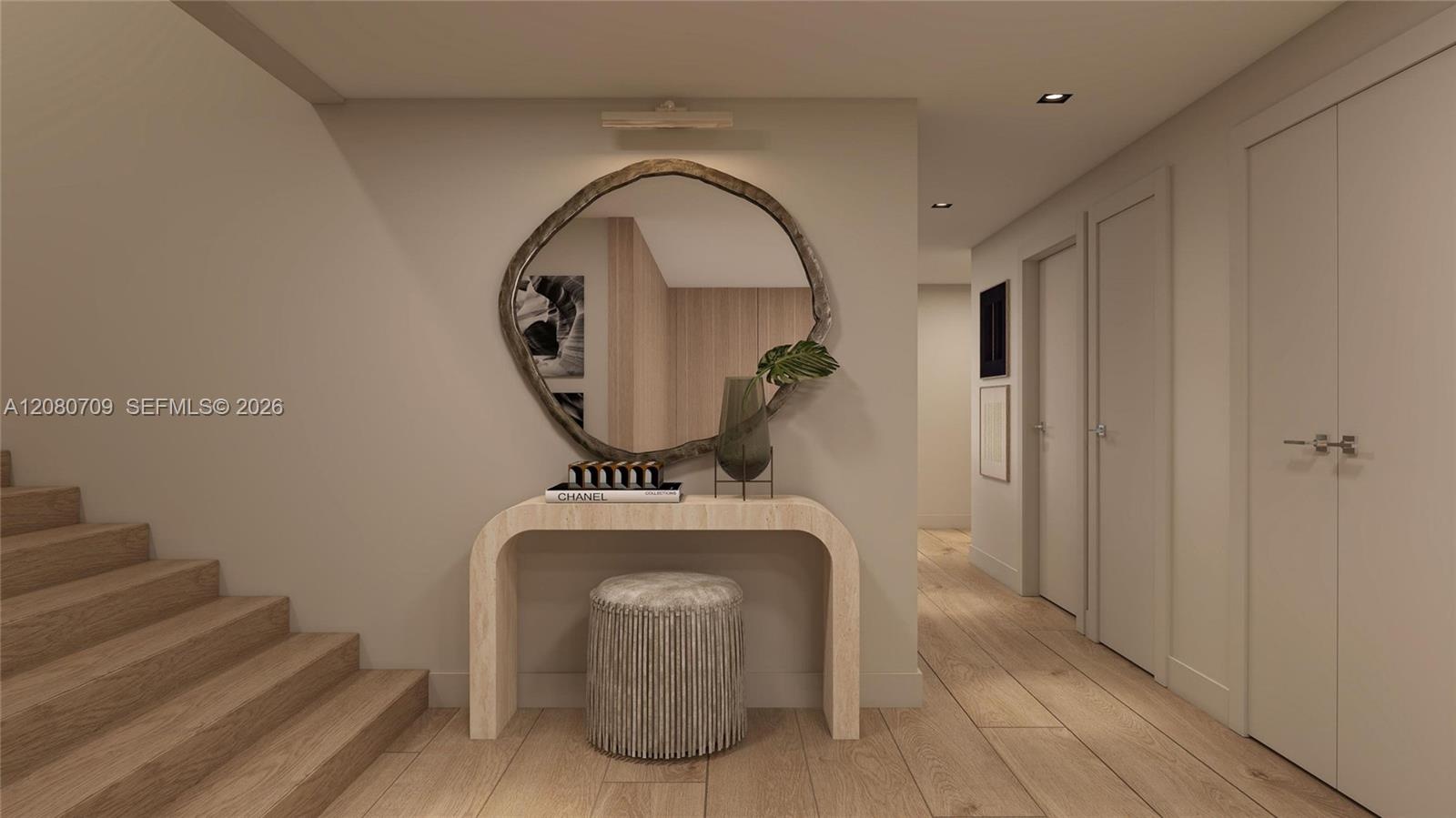 Staircase featuring wood-finish treads and a chevron-patterned accent wall, complemented by light wood-finish wall paneling and recessed ceiling light