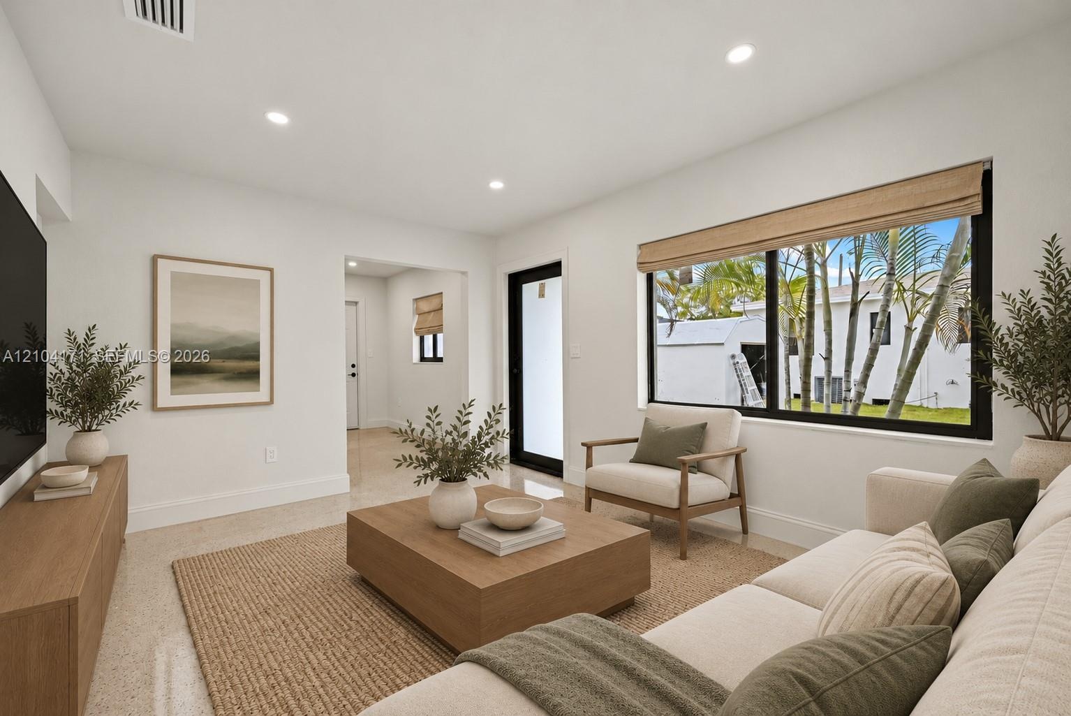Neutral-toned living space featuring recessed lighting, smooth wall finishes, and polished flooring