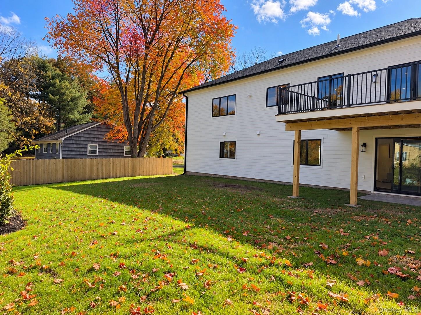Spacious Backyard & Deck | Digitally Enhanced – Enjoy a generous, level backyard with beautiful seasonal foliage, and an elevated deck overlooking the
