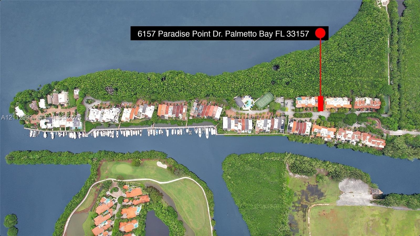 Aerial perspective of waterfront property featuring direct waterway access, deep-water dockage, and dense mature vegetation