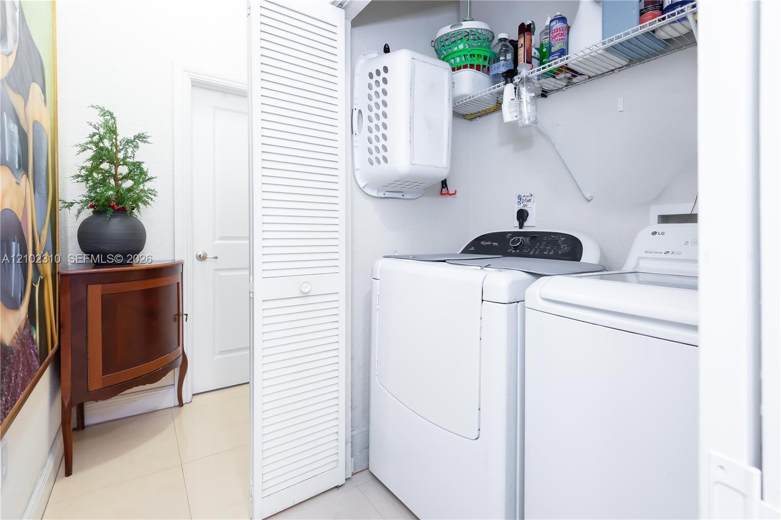 Laundry closet featuring louvered bifold doors and wire shelving