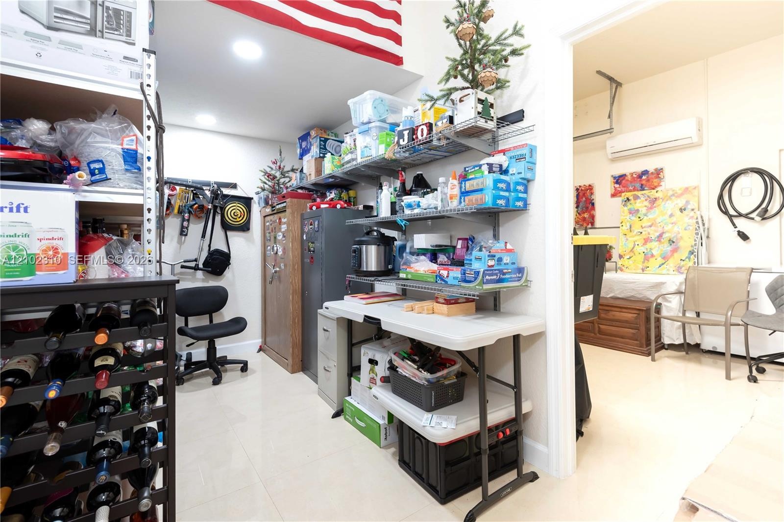 Garage space featuring wall-mounted wire shelving, recessed lighting, and a dedicated ductless mini-split climate control system