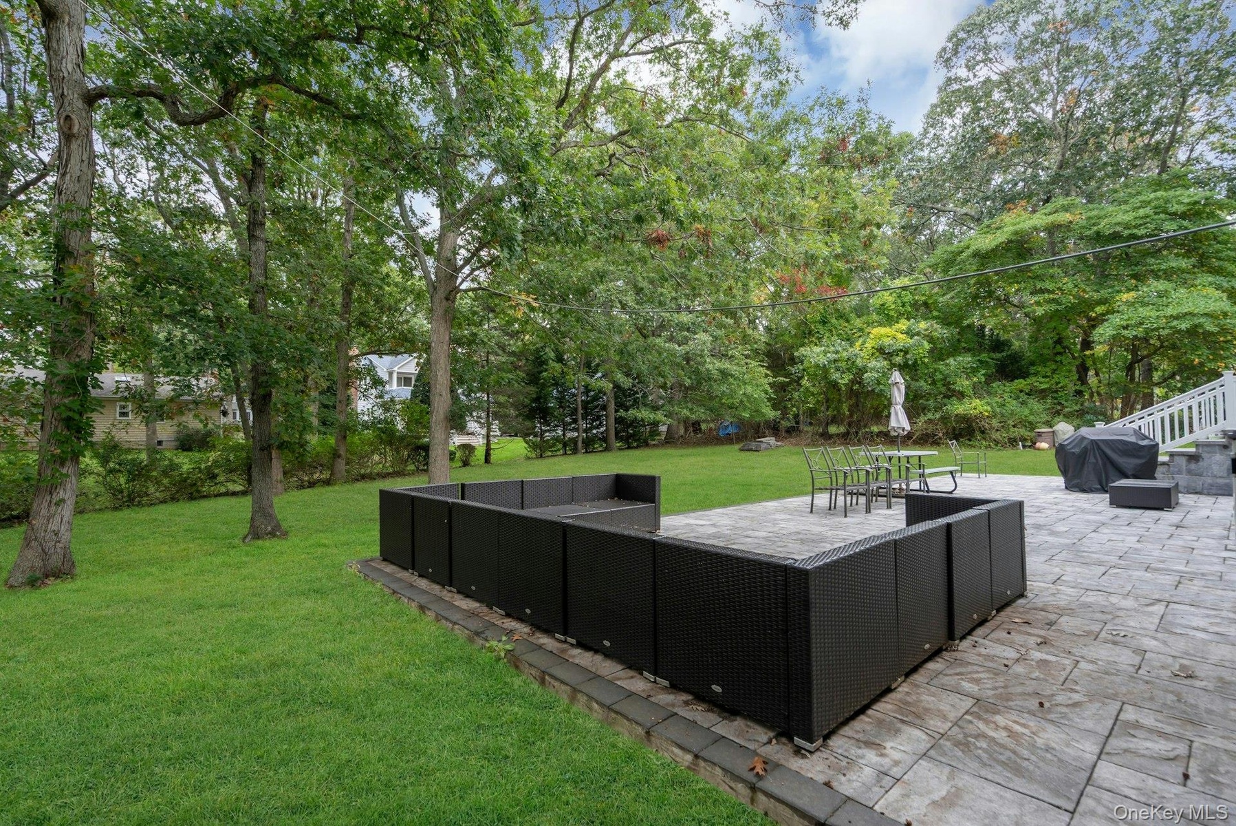 Rear patio featuring natural stone paving