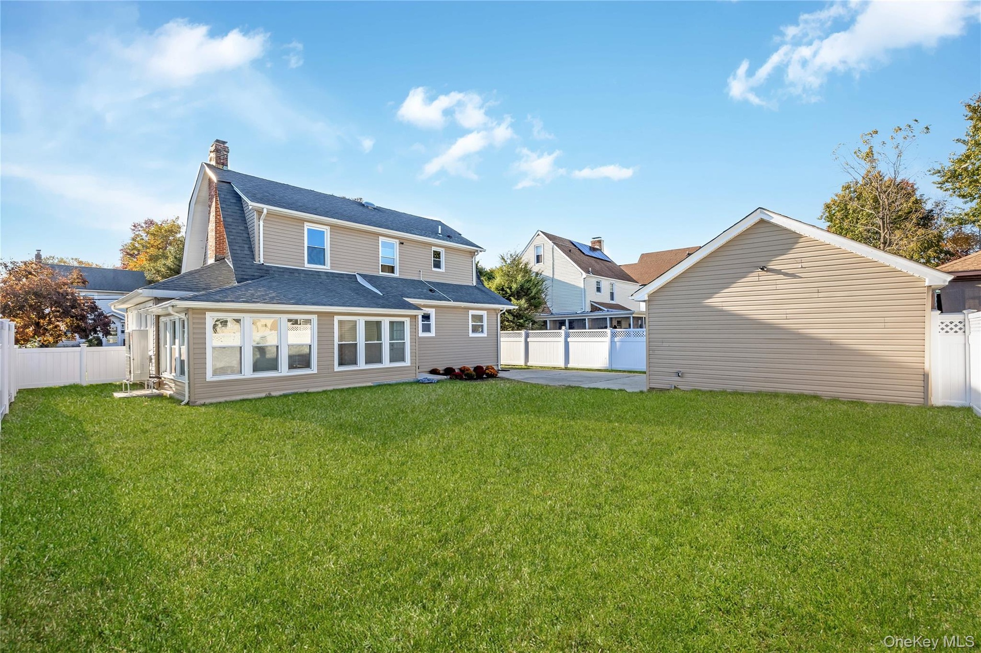 Expansive backyard featuring a level lawn, detached 2 car garage with electric, and perimeter vinyl fencing. Grass is virtually enhanced