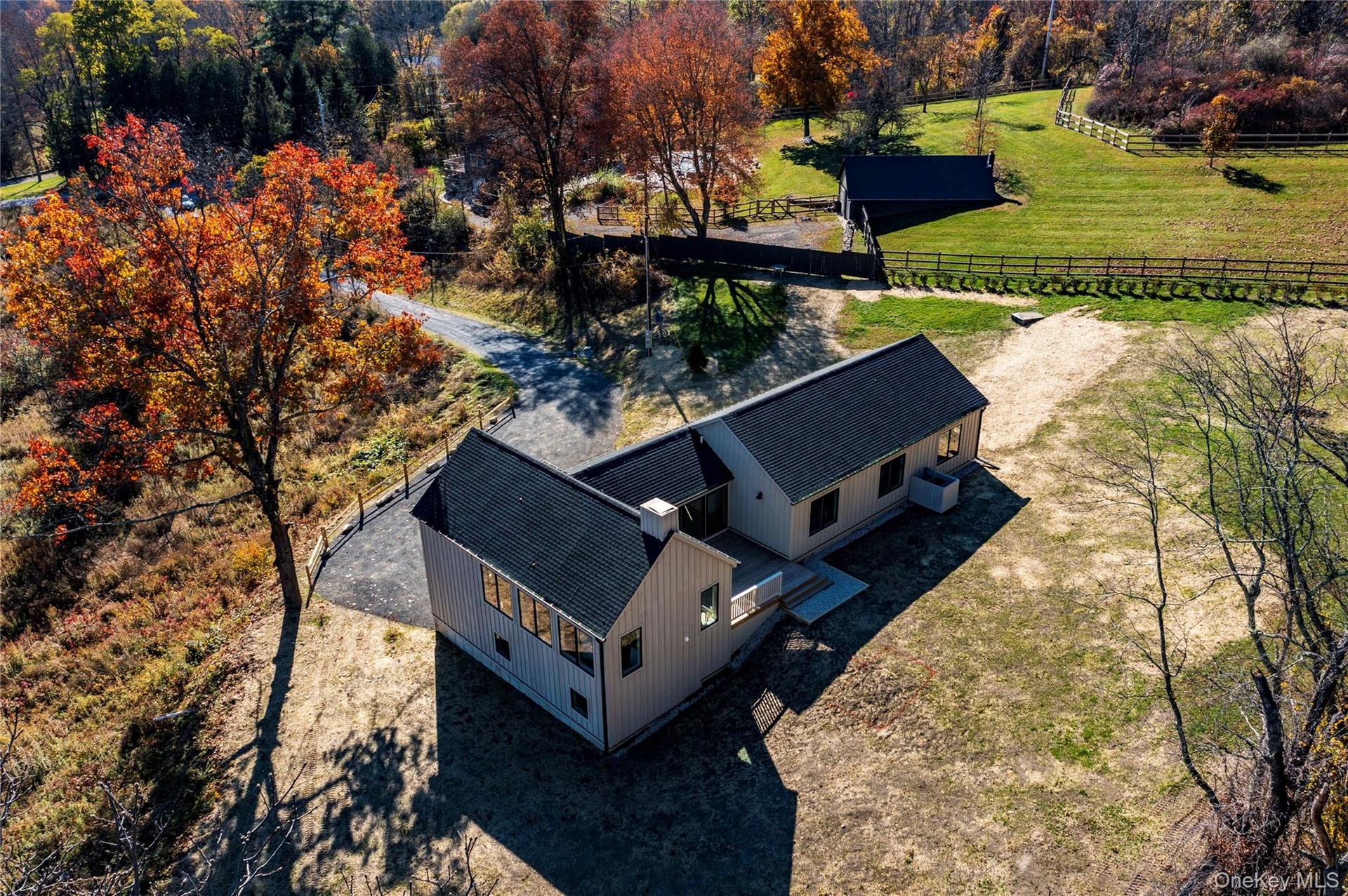 Aerial View of Home with Surrounding Lawns & Trees