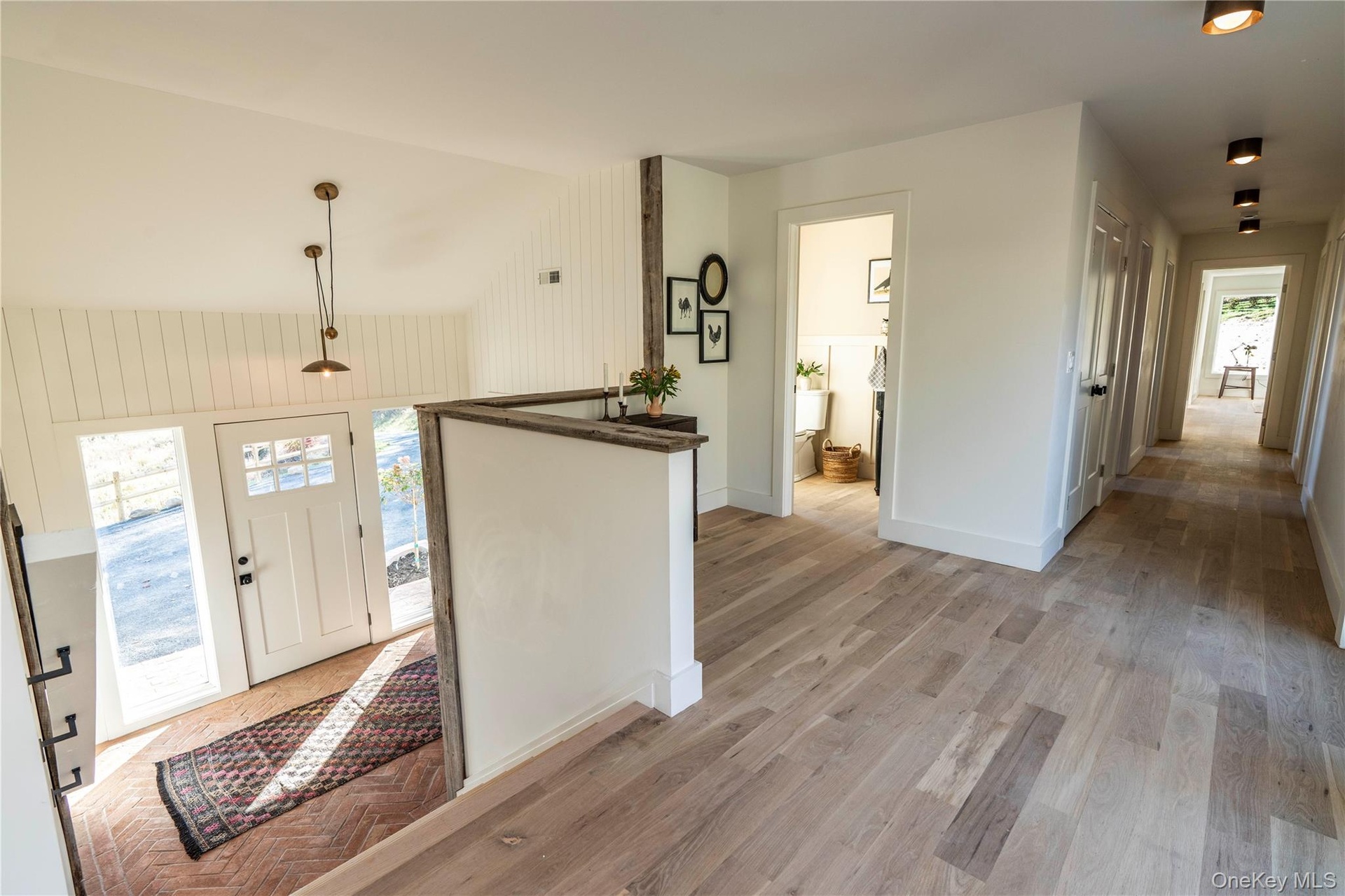 Sunny Foyer with Steps Leading to Large First Floor Landing