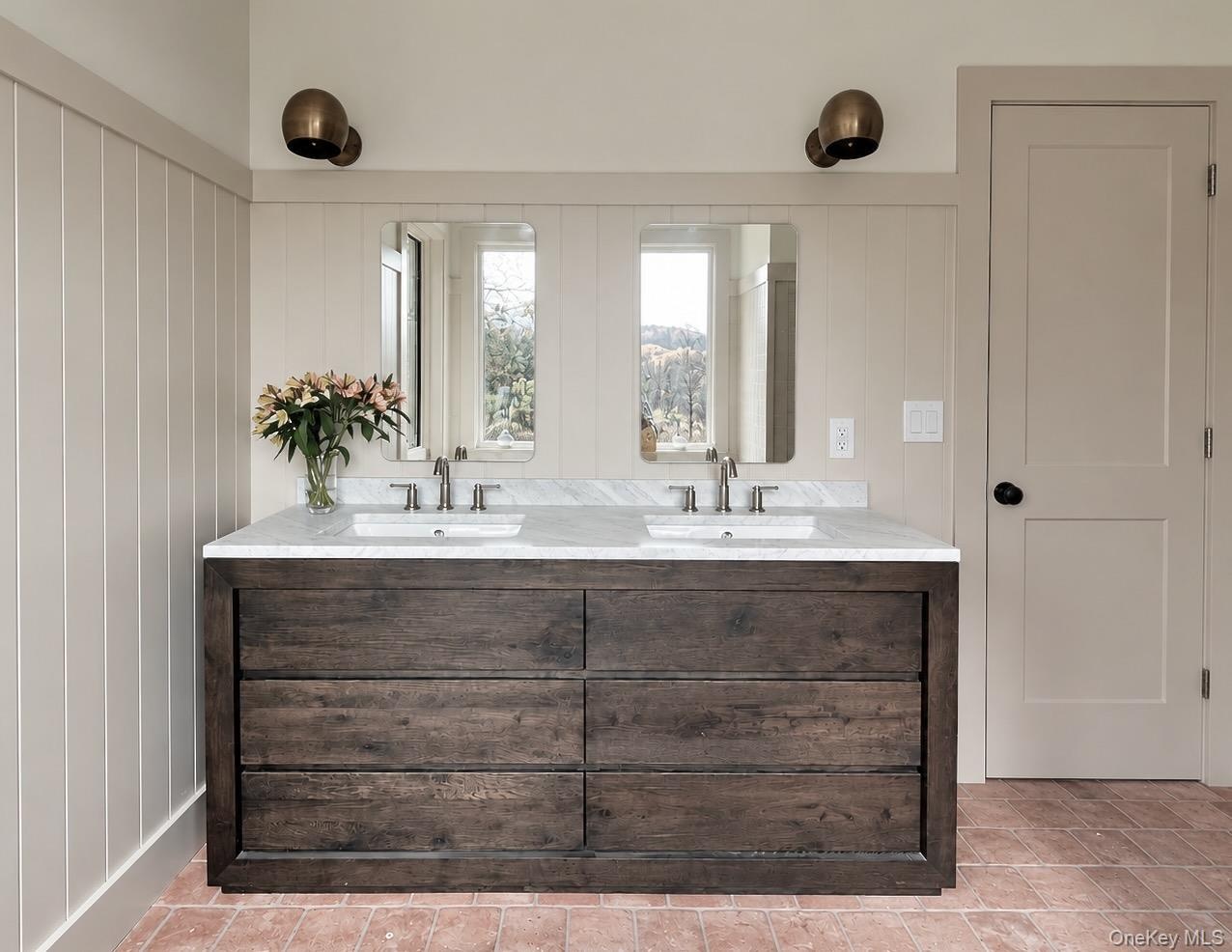 Two Sink Vanity with a Carrera Marble Top & Nickel Fixtures