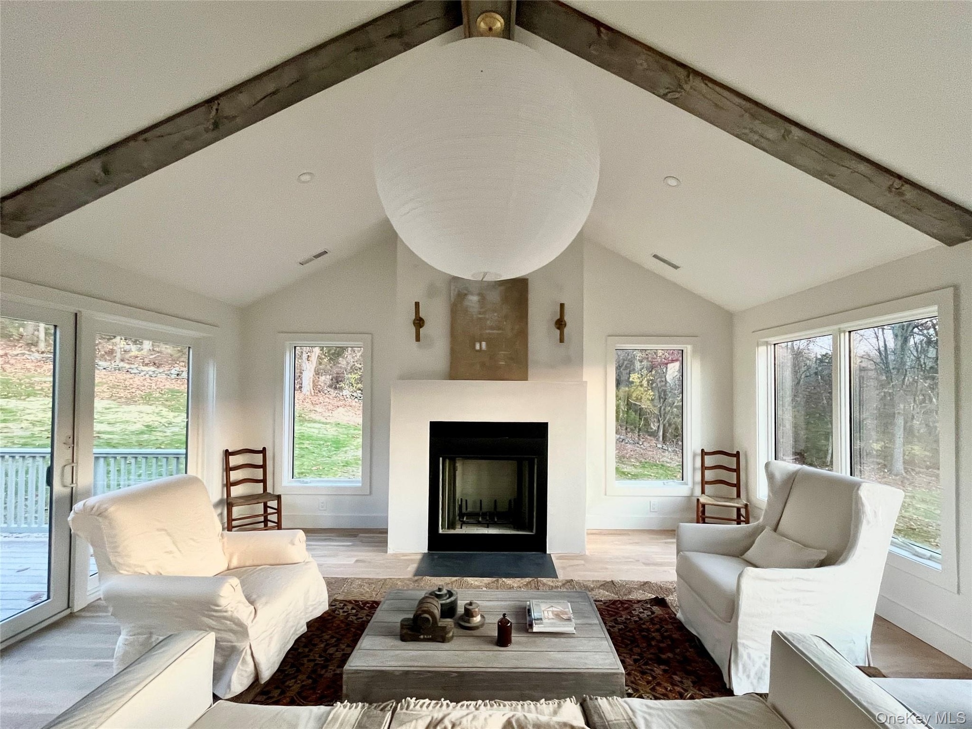 LR Walls of Windows & Views with a Wood Burning Fireplace