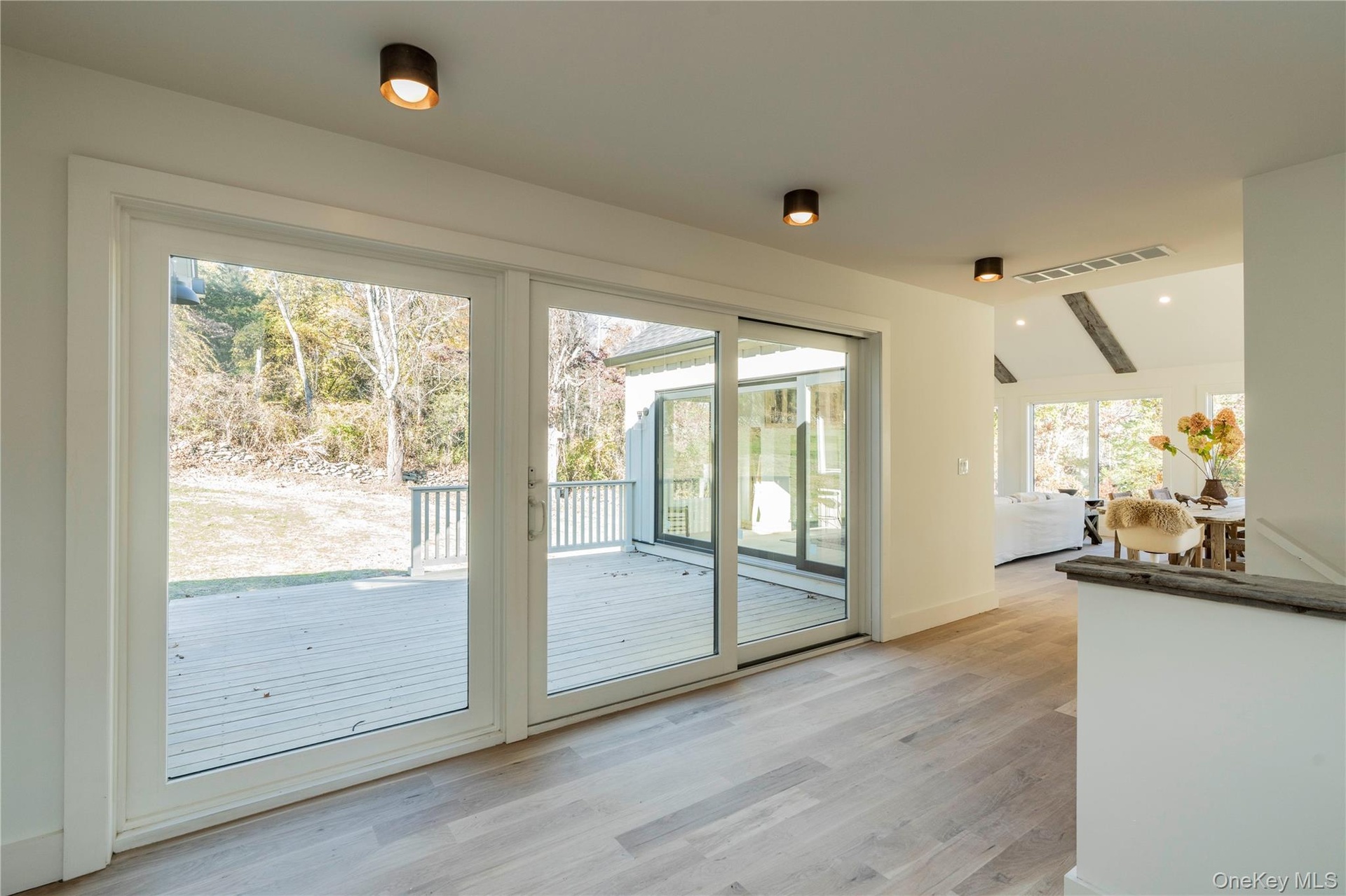 Landing Opens to a Wall of Sliding Glass Doors to Back Deck