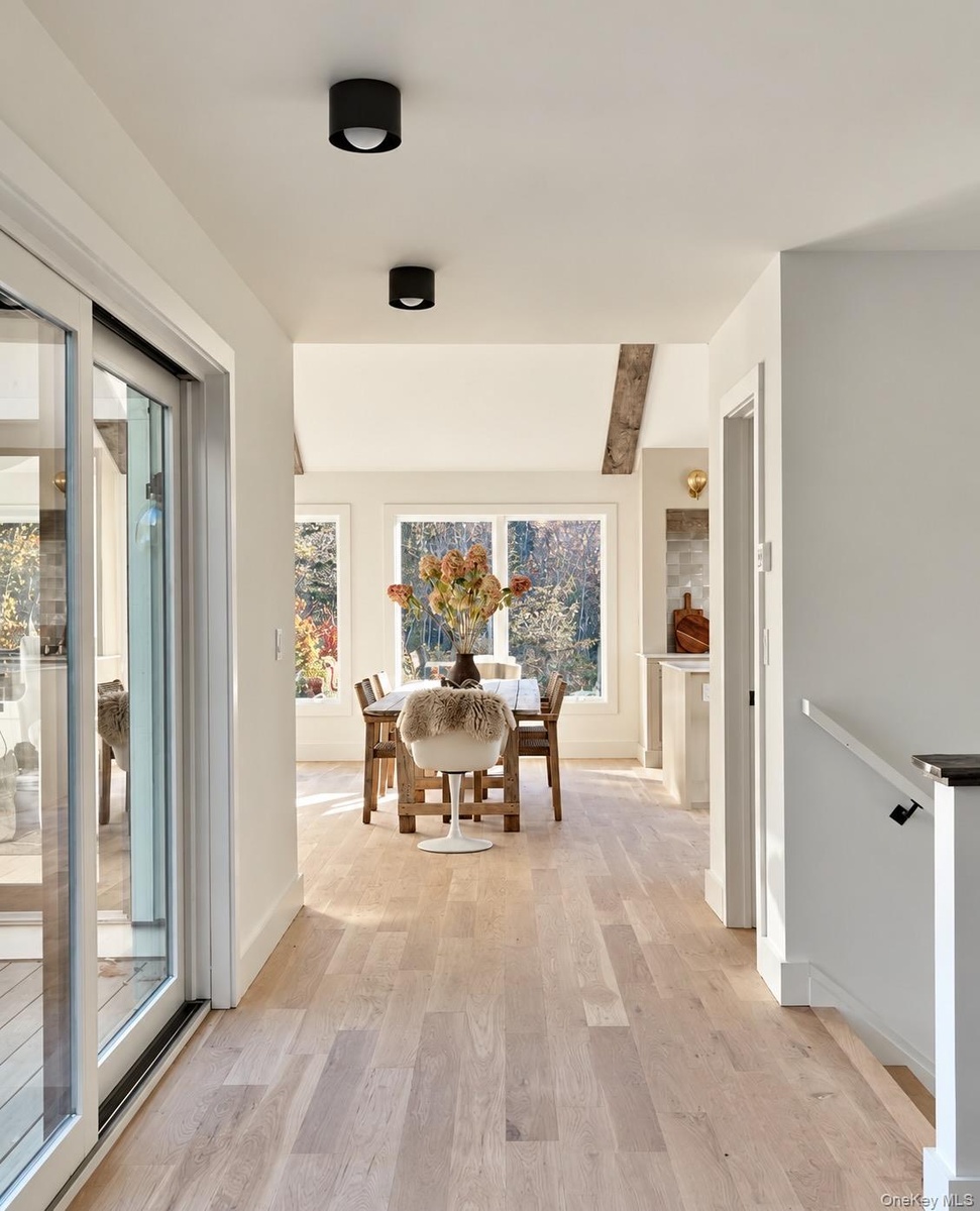 Open Hallway Leads to Great Room & Glass Doors to Deck