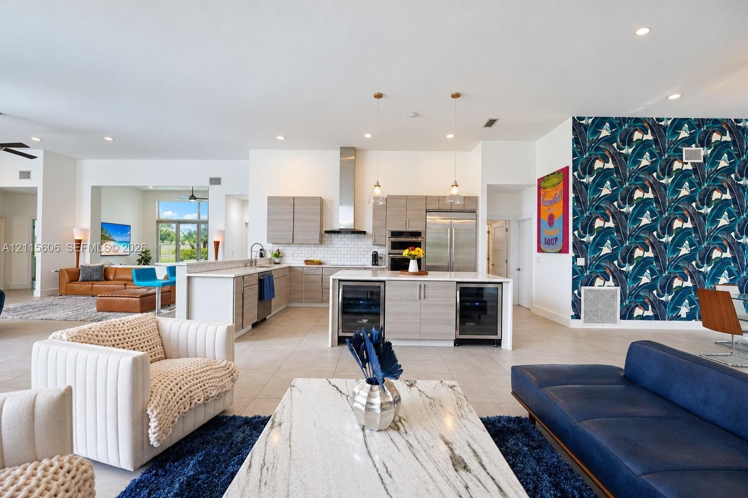 Kitchen featuring custom horizontal-grain cabinetry, stainless steel appliances, a subway tile backsplash, and a central island with dual under-counte