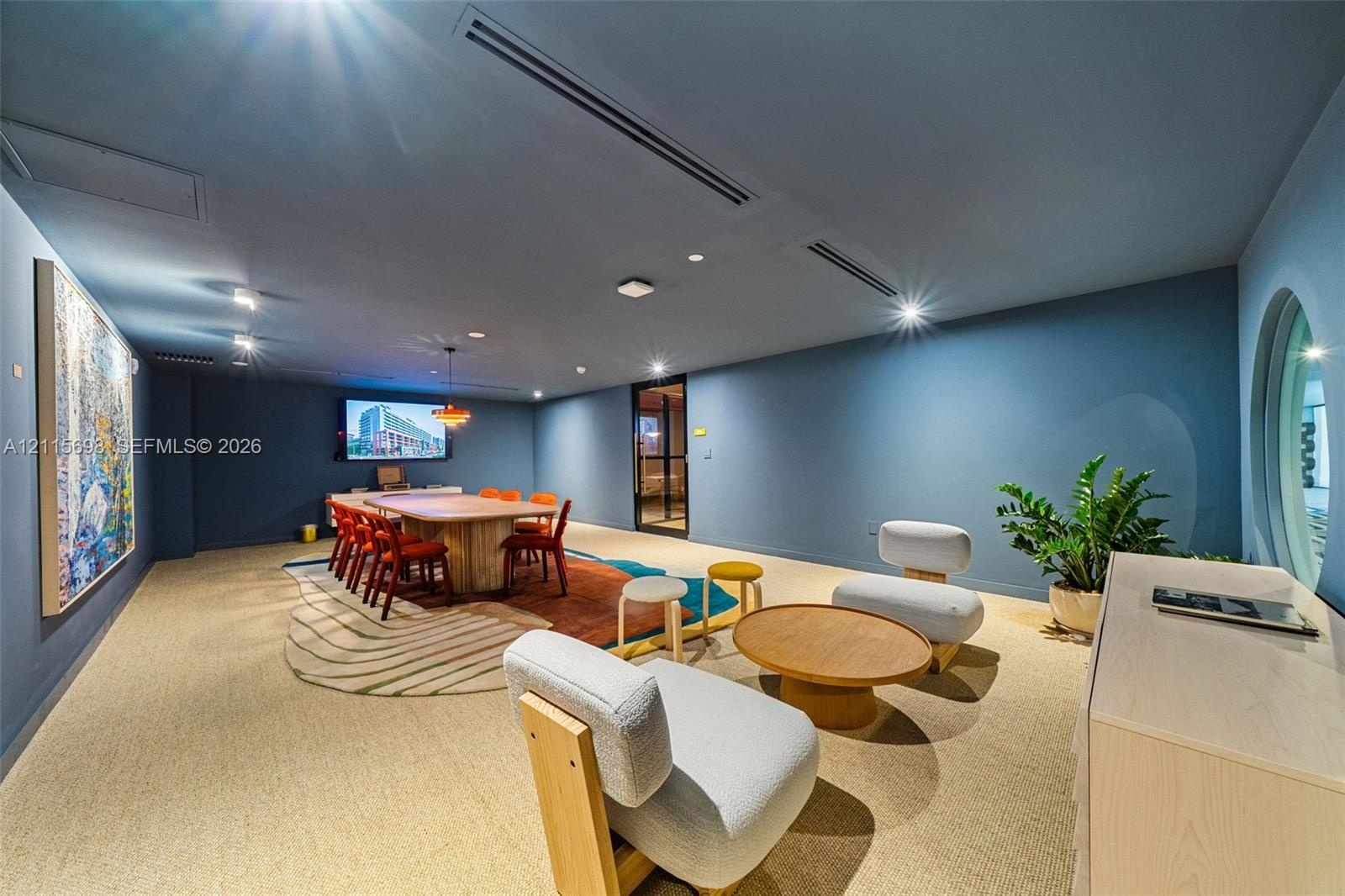 Conference rooom with spacious interior featuring integrated ceiling lighting, recessed air conditioning system, circular window, and neutral wall-to-
