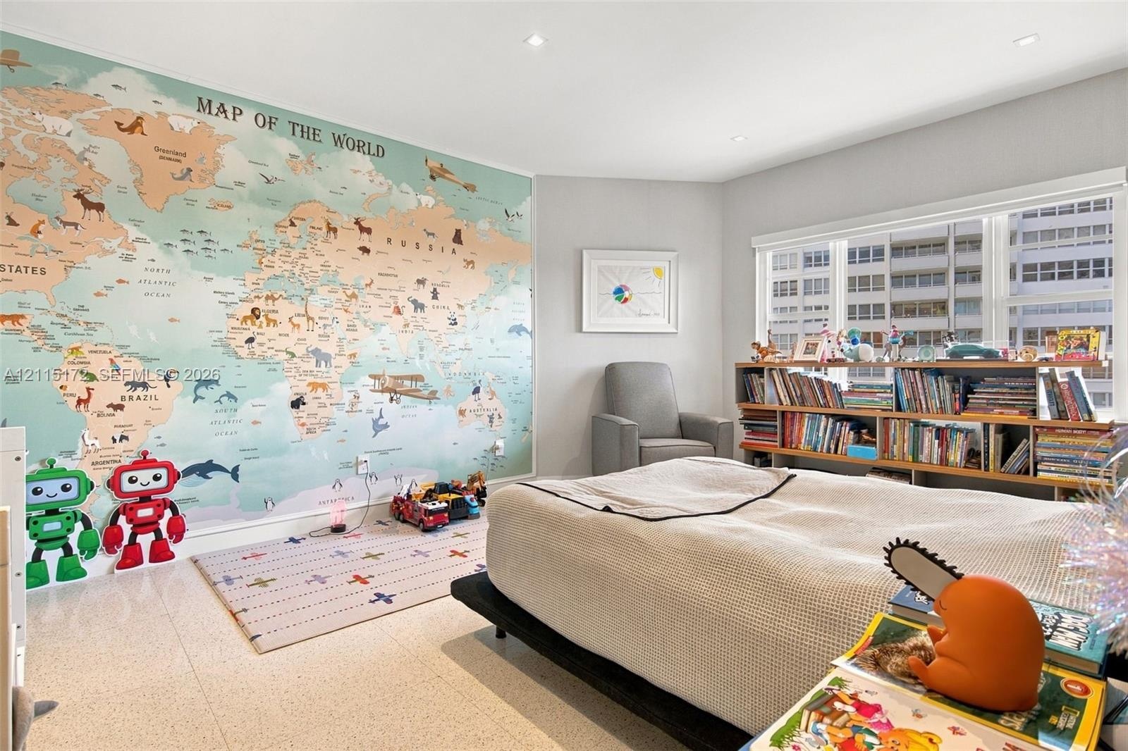 Room featuring a large-scale map wall mural, recessed ceiling lighting, and large windows with integrated blinds, finished with light-toned stone-styl