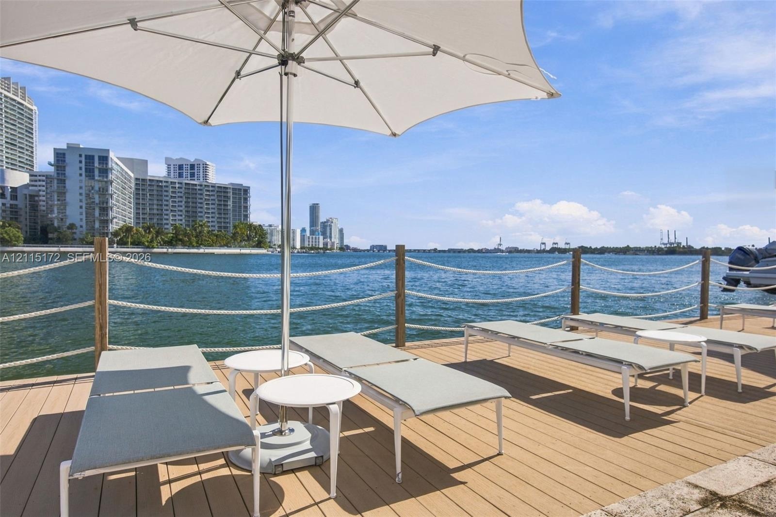 Waterfront wood-finish deck featuring a rope-rail perimeter