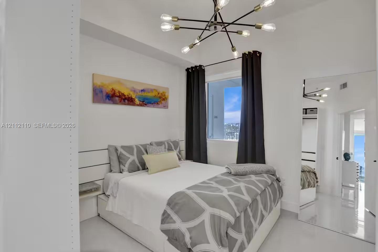 Multi-arm sputnik-style chandelier, horizontal panel wall detailing, built-in shelving, and reflective smooth-finish flooring