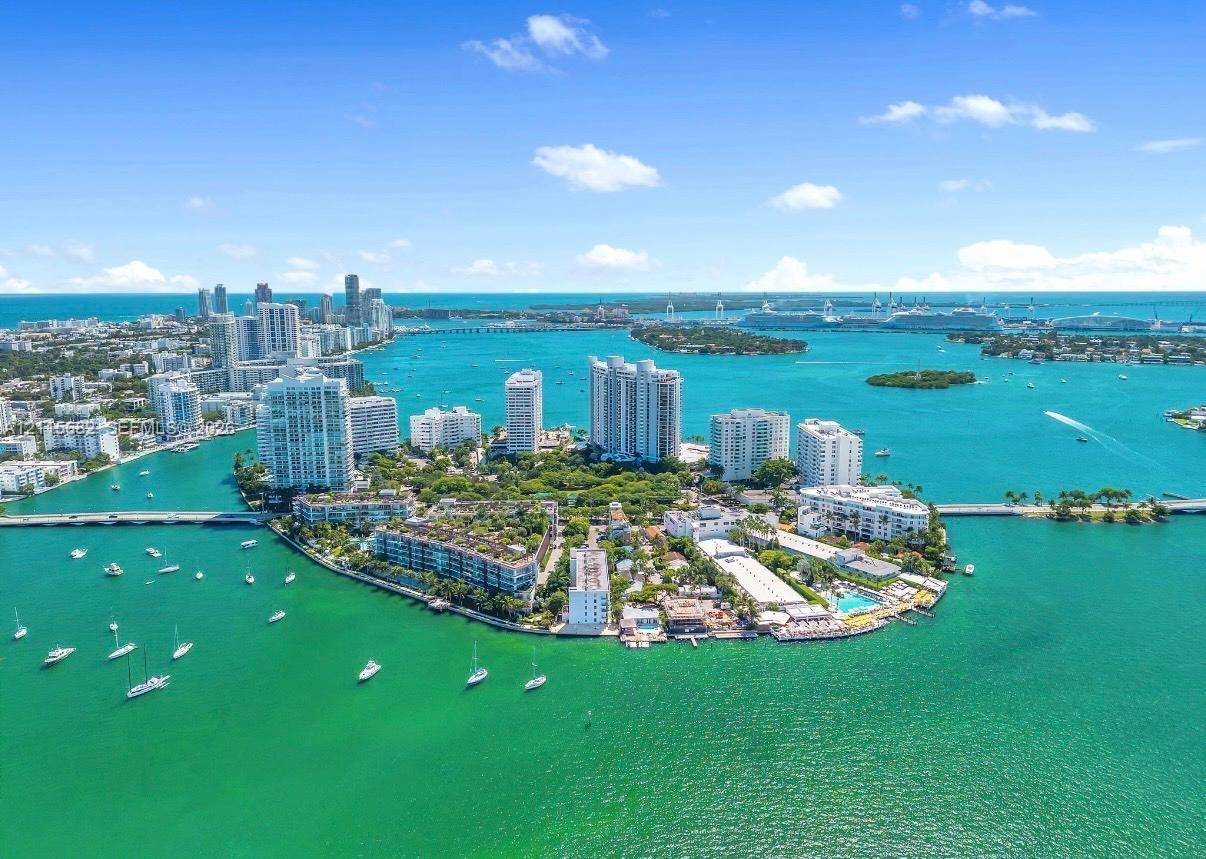 Aerial perspective of a coastal island community featuring waterfront positioning, expansive water surroundings, and proximity to municipal skylines