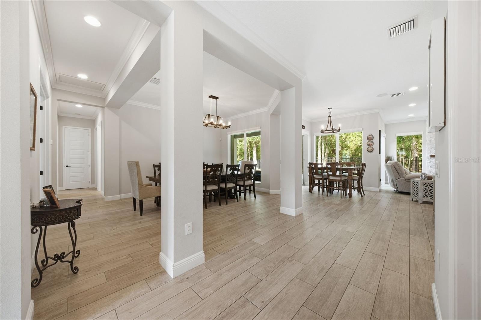 Formal dining open to home yet defined as an elegant space