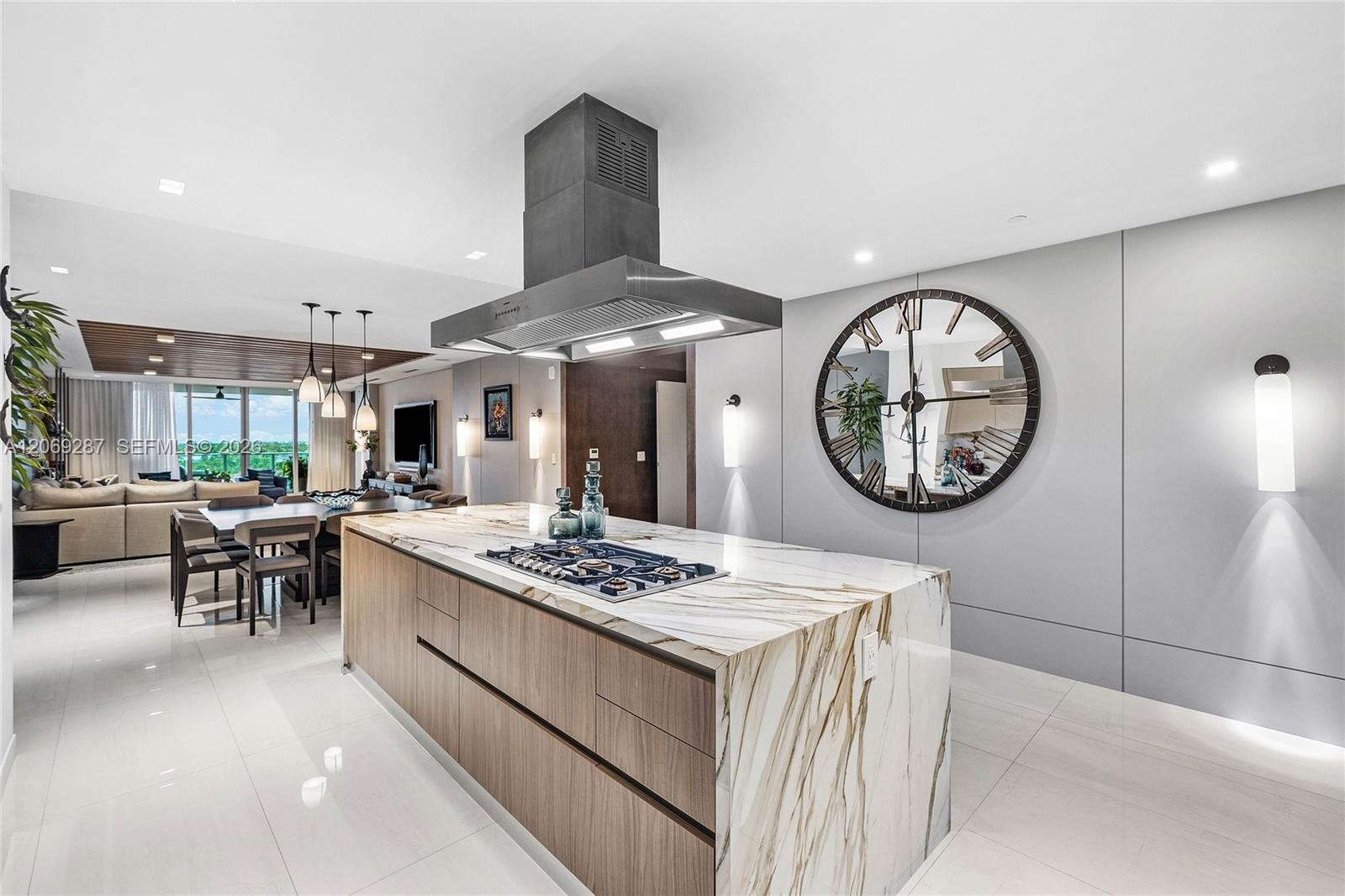 A sophisticated Italian-designed kitchen featuring custom cabinetry, premium Gaggenau appliances, gas cooking and an elegant island ideal for entertai