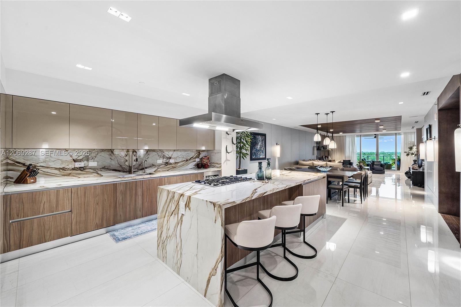 A sophisticated Italian-designed kitchen featuring custom cabinetry, premium Gaggenau appliances, gas cooking and an elegant island ideal for entertai