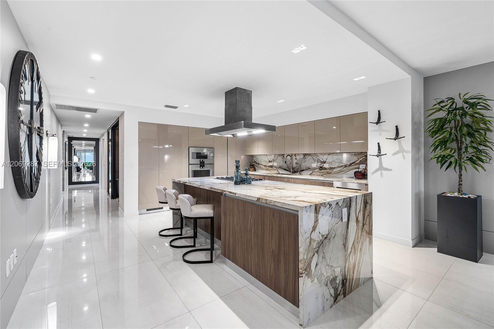 A sophisticated Italian-designed kitchen featuring custom cabinetry, premium Gaggenau appliances, gas cooking and an elegant island ideal for entertai