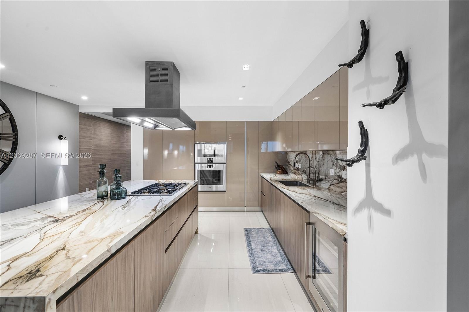 A sophisticated Italian-designed kitchen featuring custom cabinetry, premium Gaggenau appliances, gas cooking and an elegant island ideal for entertai