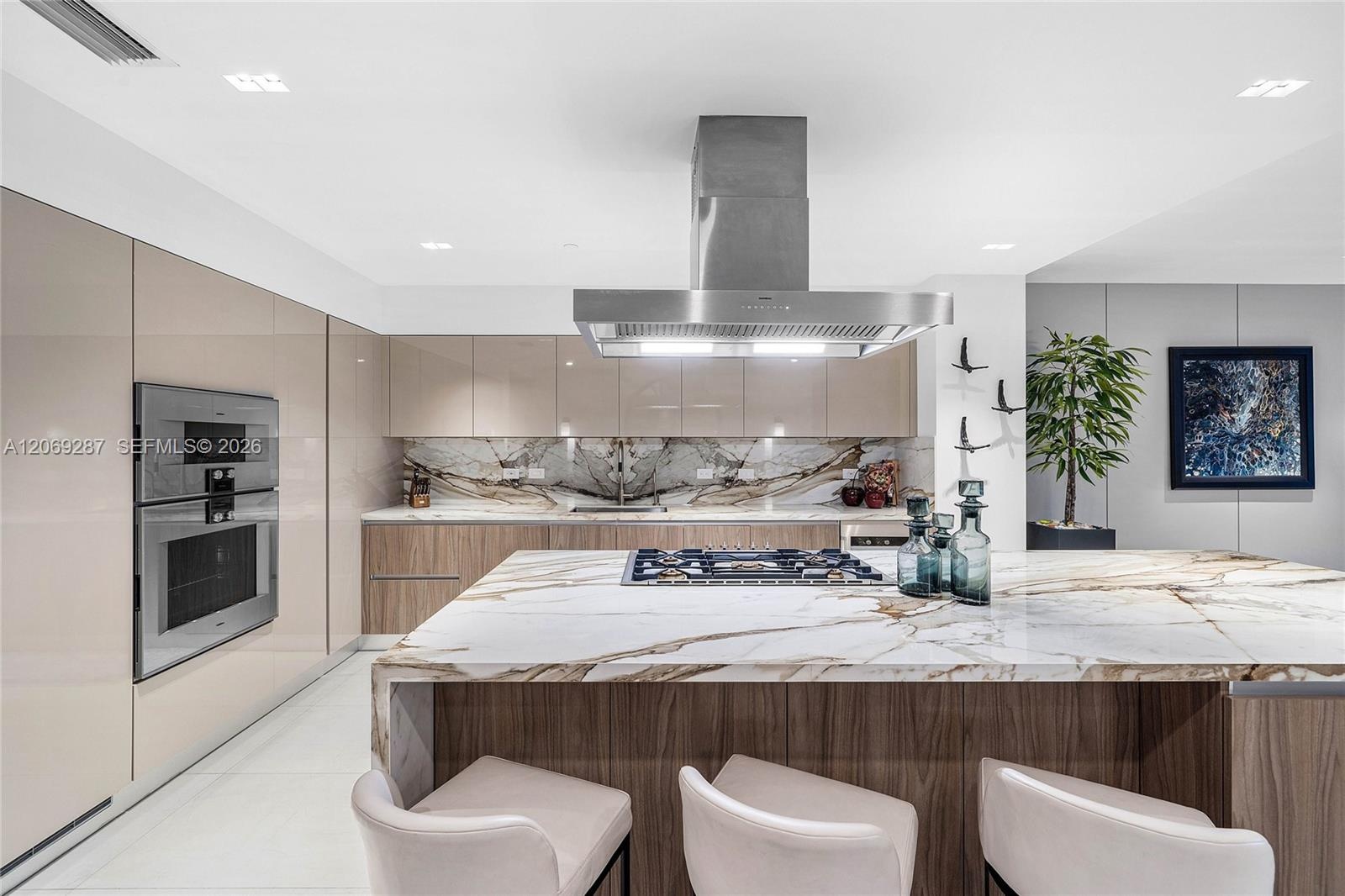 A sophisticated Italian-designed kitchen featuring custom cabinetry, premium Gaggenau appliances, gas cooking and an elegant island ideal for entertai