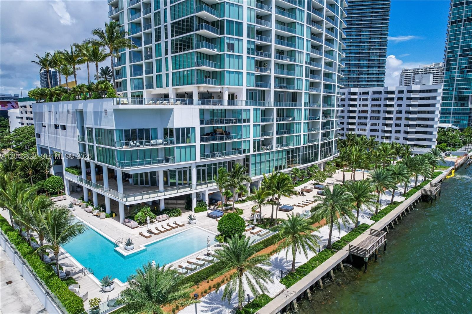 Spacious living area with wraparound windows and Miami skyline views