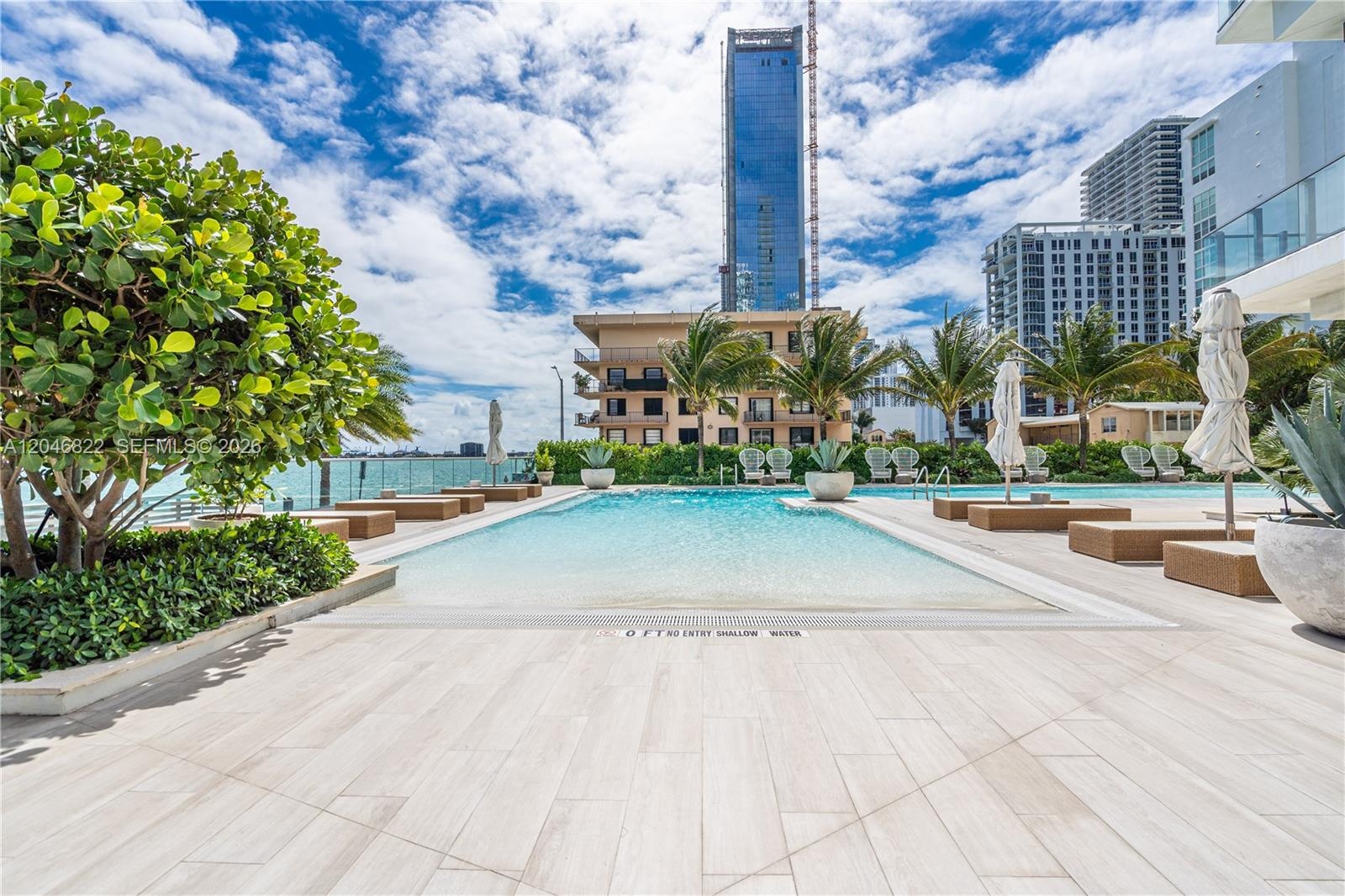 Private man-made beach and daybeds on Biscayne Bay