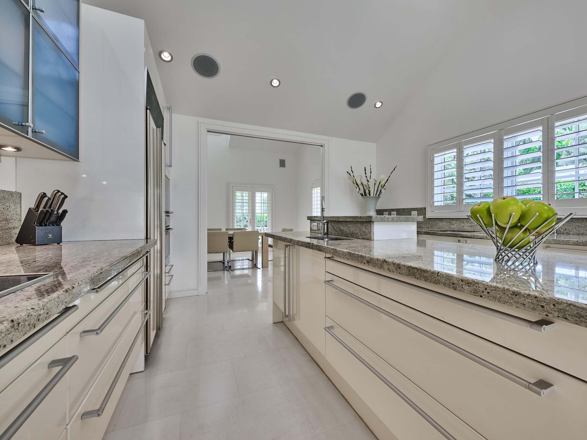 Volume Ceilings, French Doors, Wall of Windows and Dormers bring Natural Light into the Kitchen all day