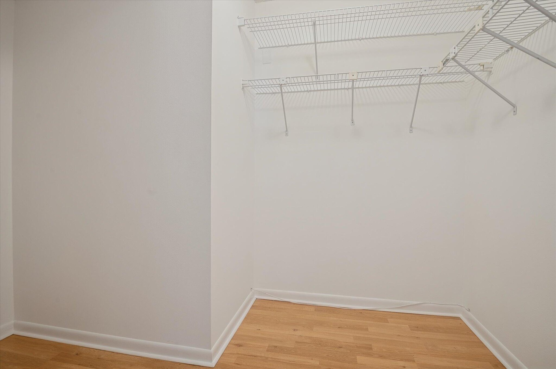 PRIMARY BEDROOM WALK-IN CLOSET.