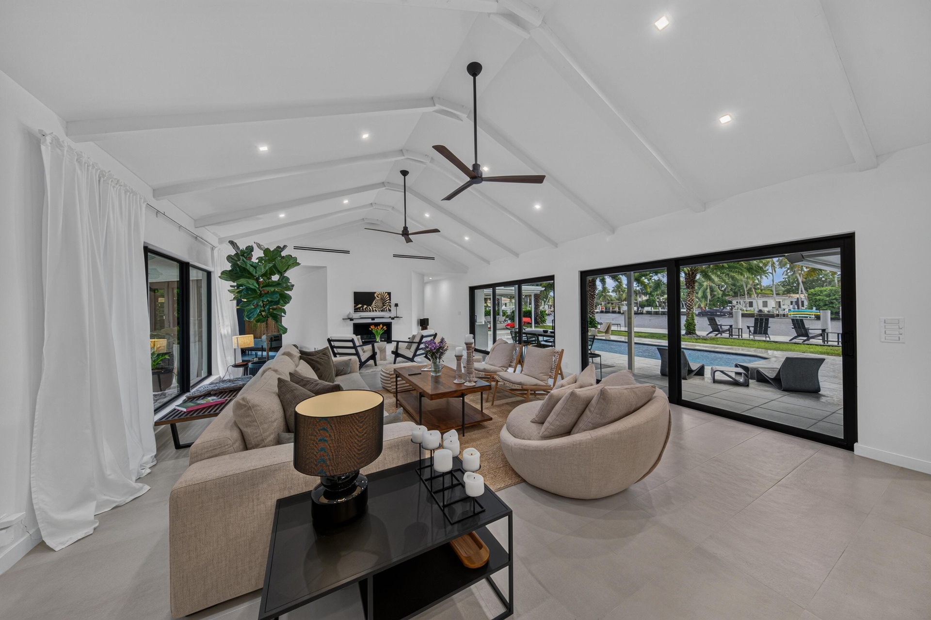 Living area with beautiful cathedral ceiling and a view of the pool