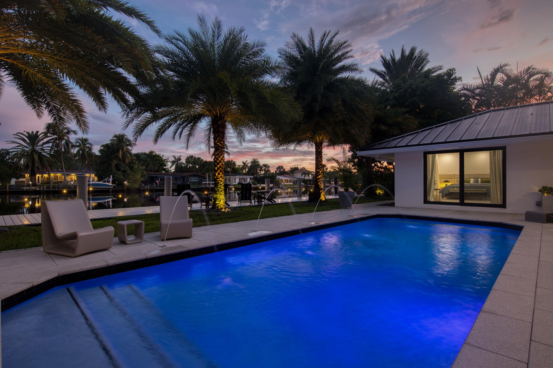 Pool at sunset with a view of the dock, and waterfront