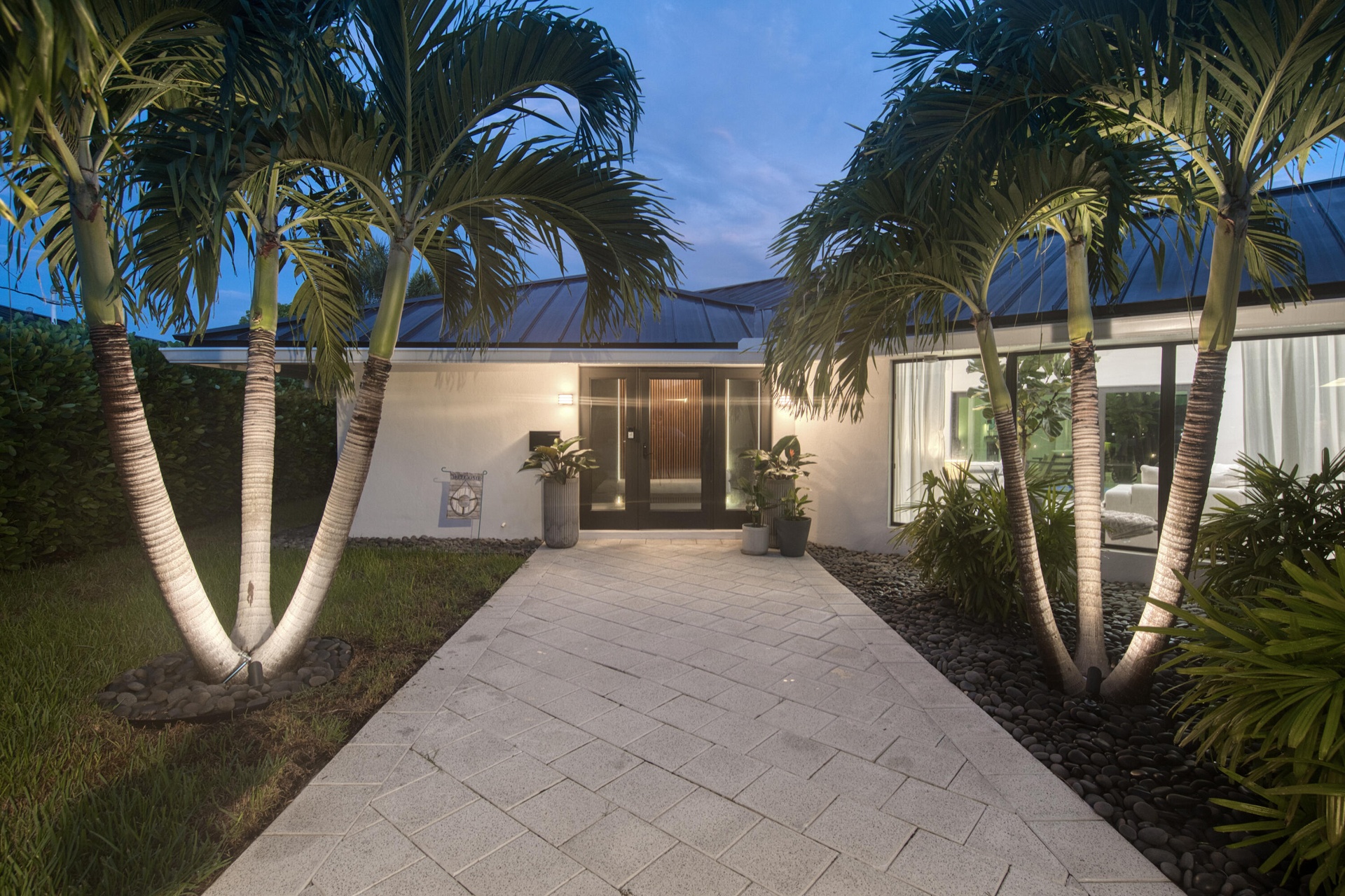 Front of home with wide private entrance with exterior lights leading to you large private foyer.