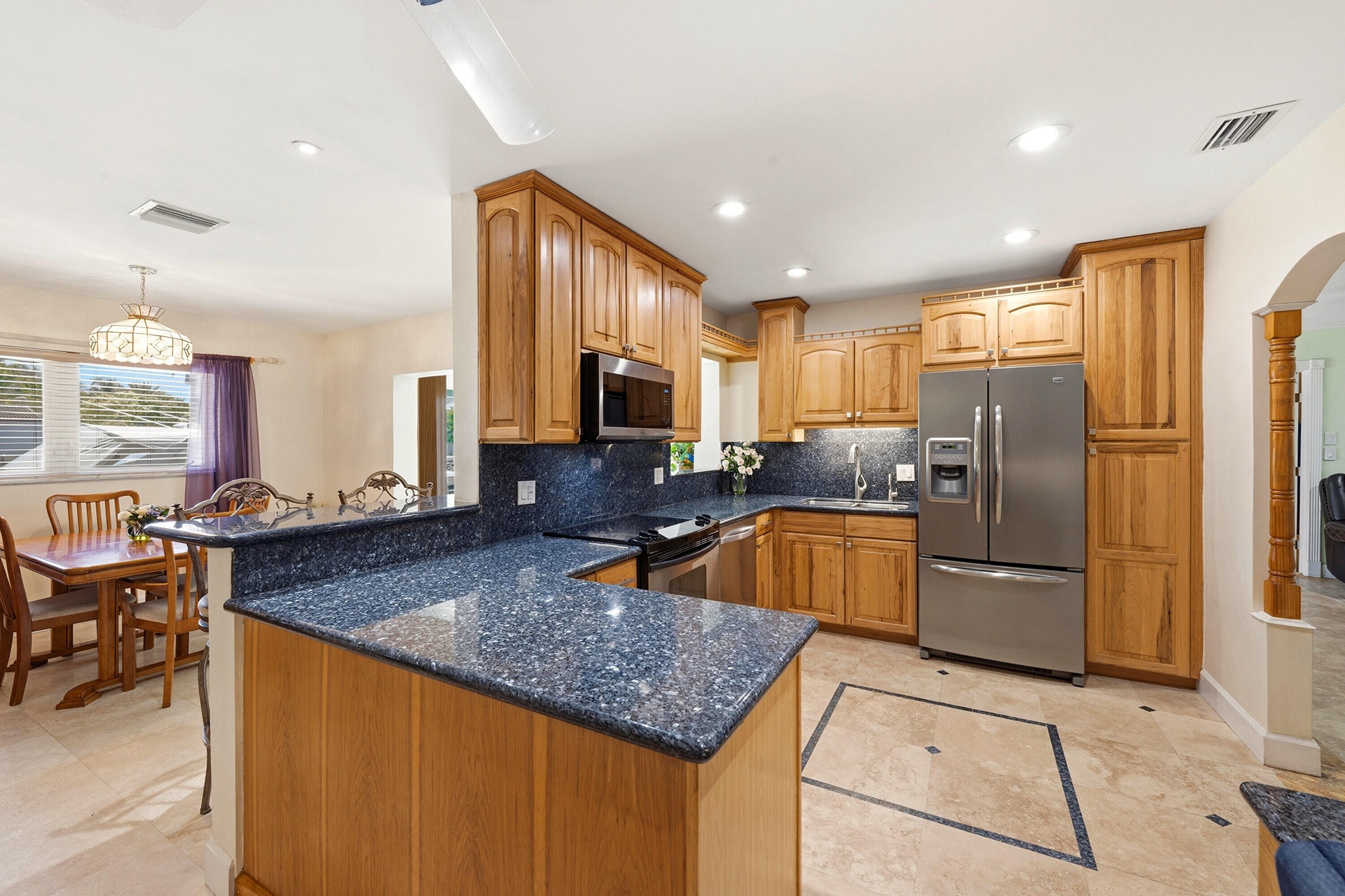 Beautiful Kitchen with Tall Custom Cabinets, Granite Countertops, 2 Snack Bars, SS Appliances & a Built-In Desk included.