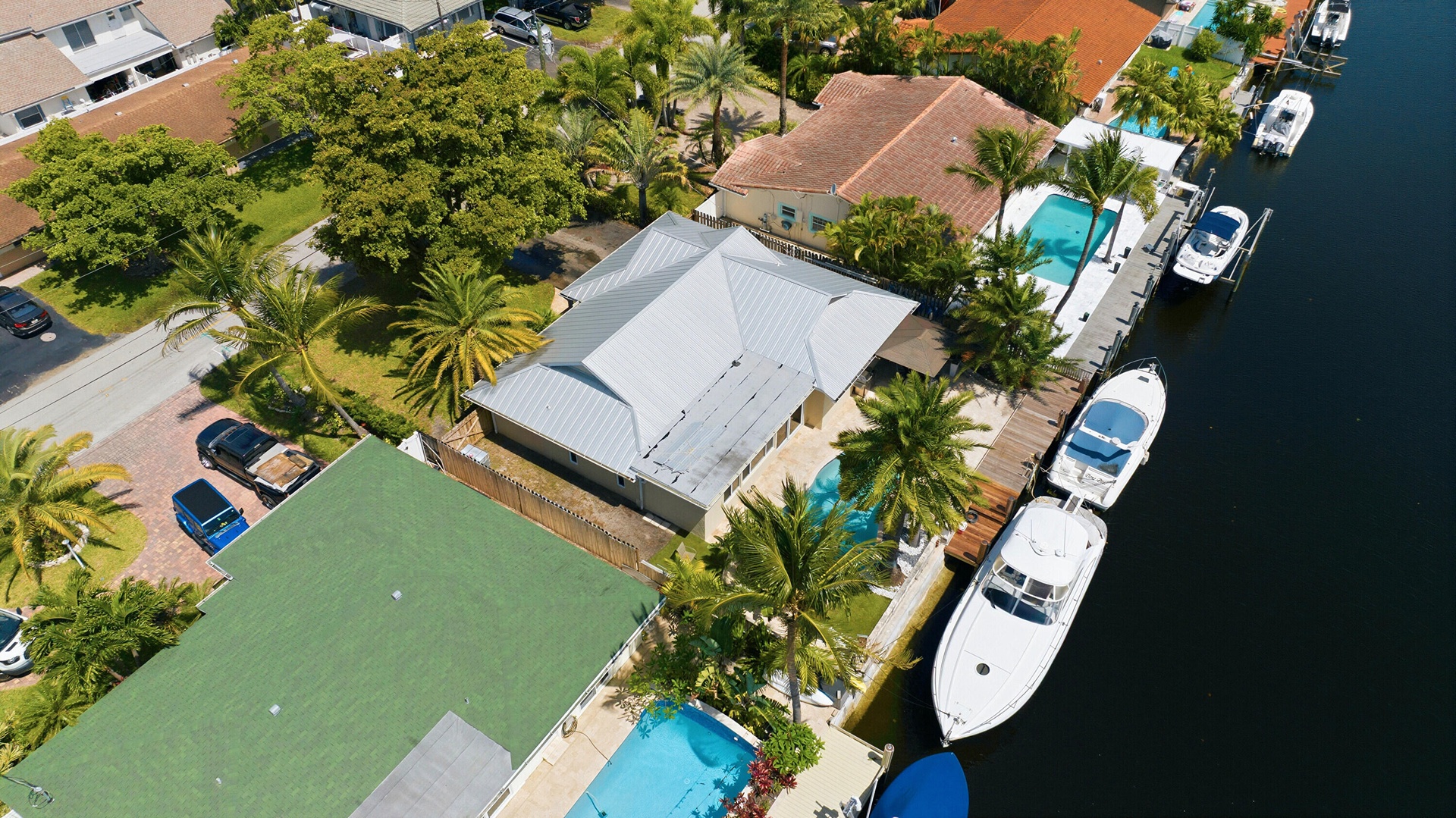 Aerial of the 40' Dock, 70' Seawall, Freeform Pool with Rock Waterfall, Covered Patio Space for Fail Safe Outdoor Patio Perfect for Enteraining. Your 