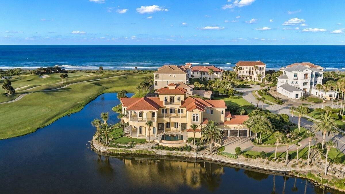 Located behind the exclusive North Gate of Hammock Dunes, this extraordinary Mediterranean estate occupies one of the community’s most iconic peninsul