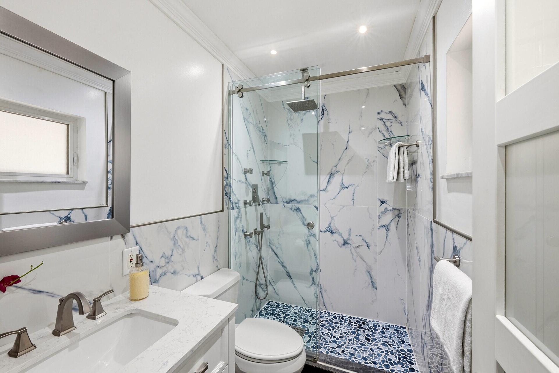 Guest Bathroom Updated 2025 with Glass Enclosed Shower and Frosted Glass Door and Window.