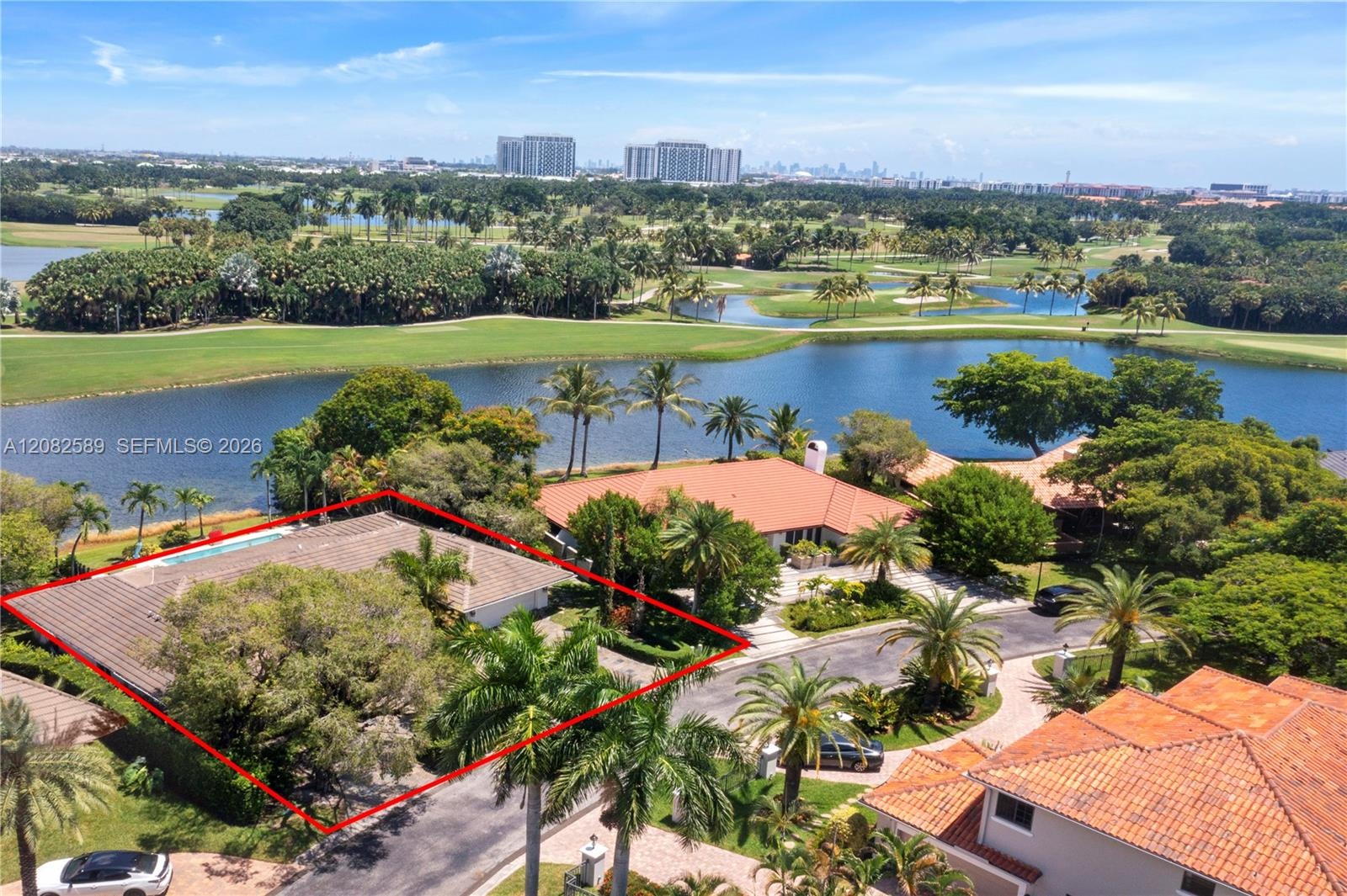 Aerial view showcasing the home’s prime water setting, surrounded by lush golf course landscapes and tranquil lake views.