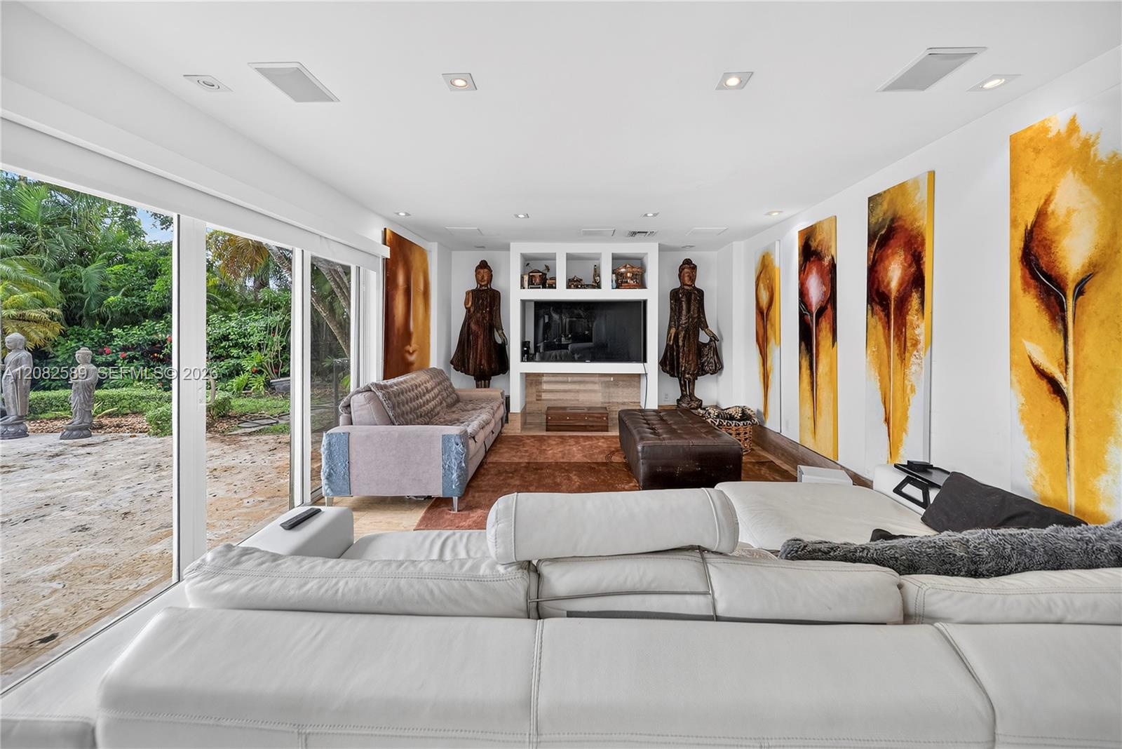 Spacious home theater/media room with built-in audiovisual components and Pioneer entertainment system.