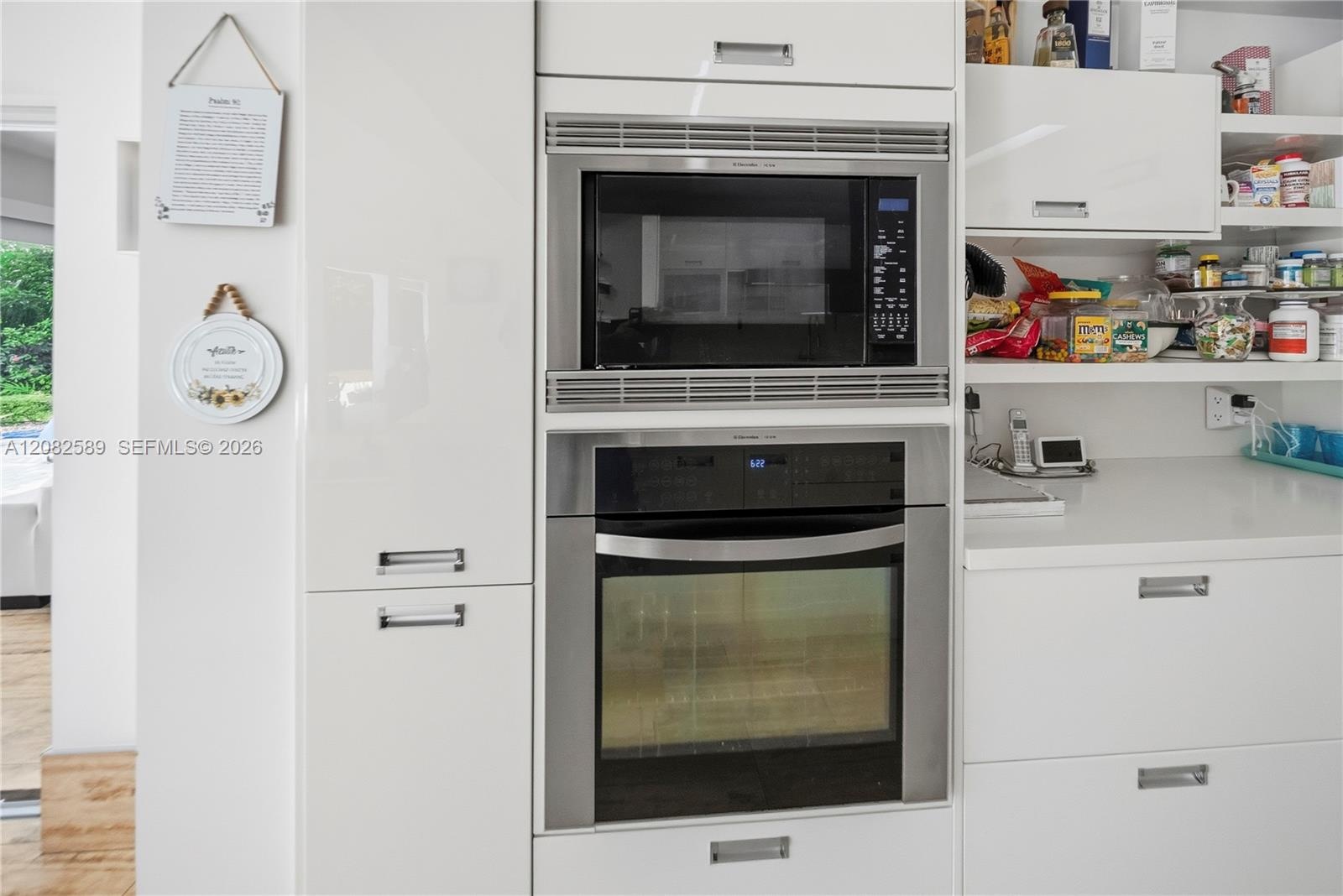 Built-in stainless-steel microwave and oven seamlessly integrated into the modern cabinetry.
