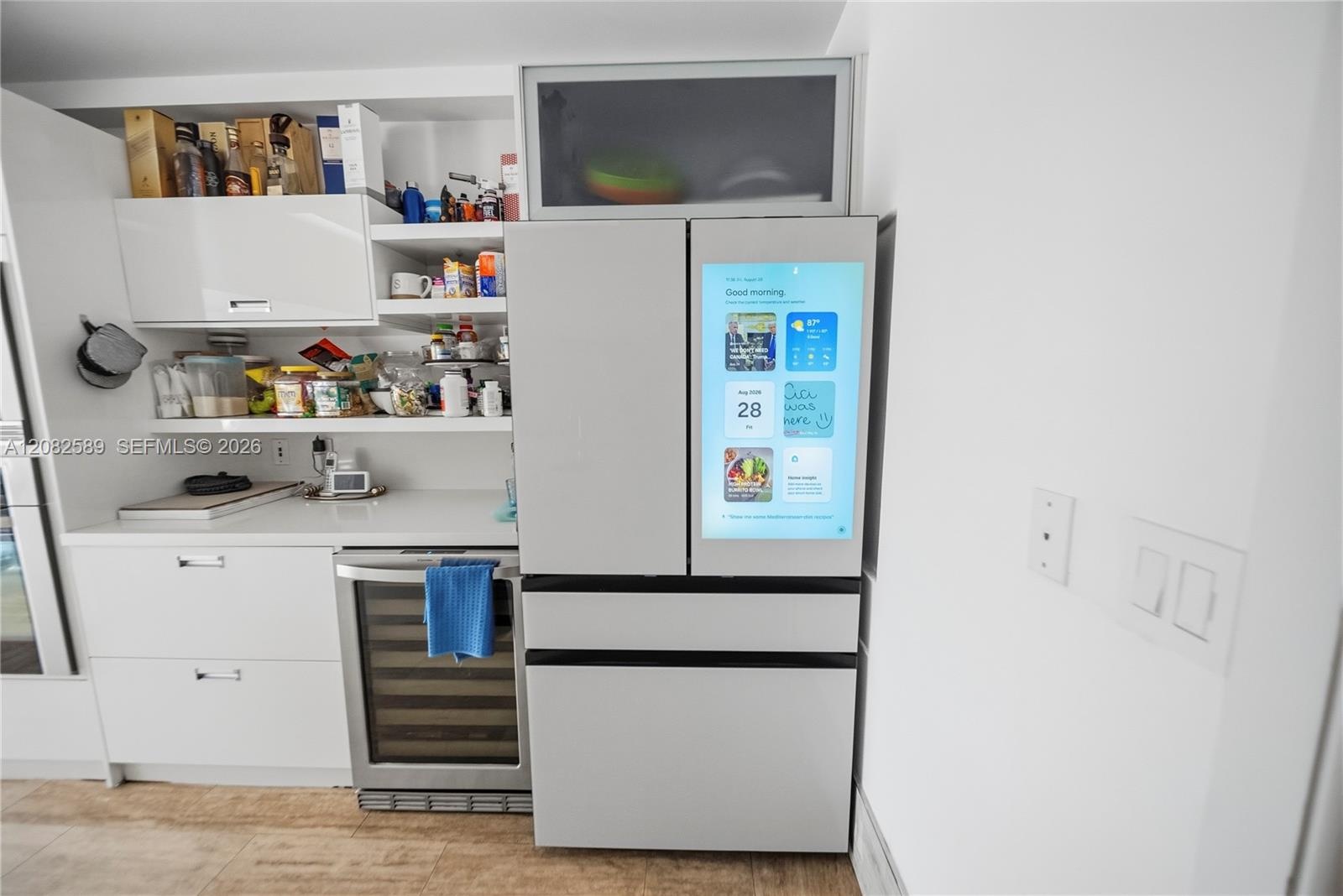 Modern kitchen featuring a Samsung smart French-door refrigerator with integrated touchscreen display.