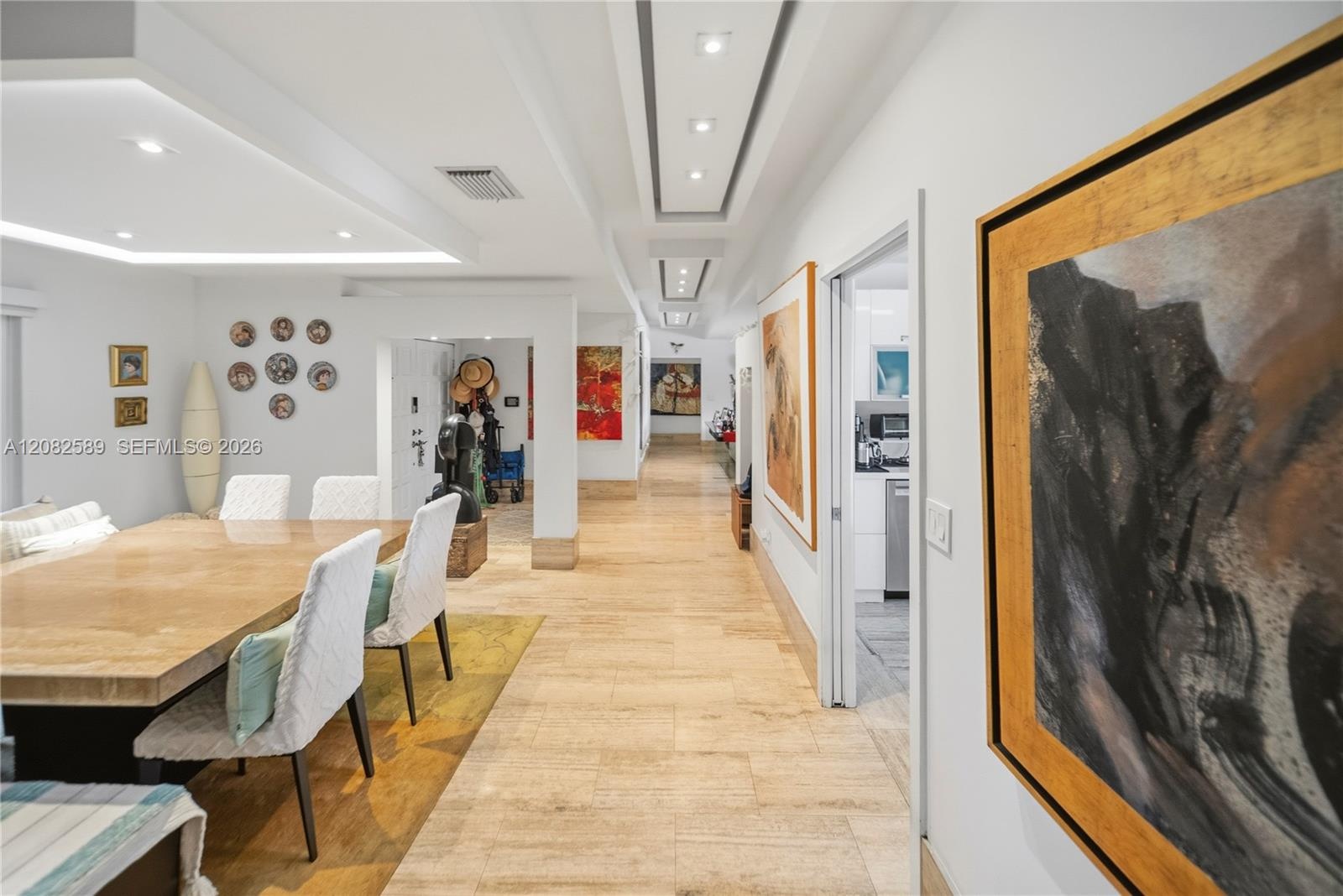 Open dining area with refined finishes and a beautifully illuminated hallway.