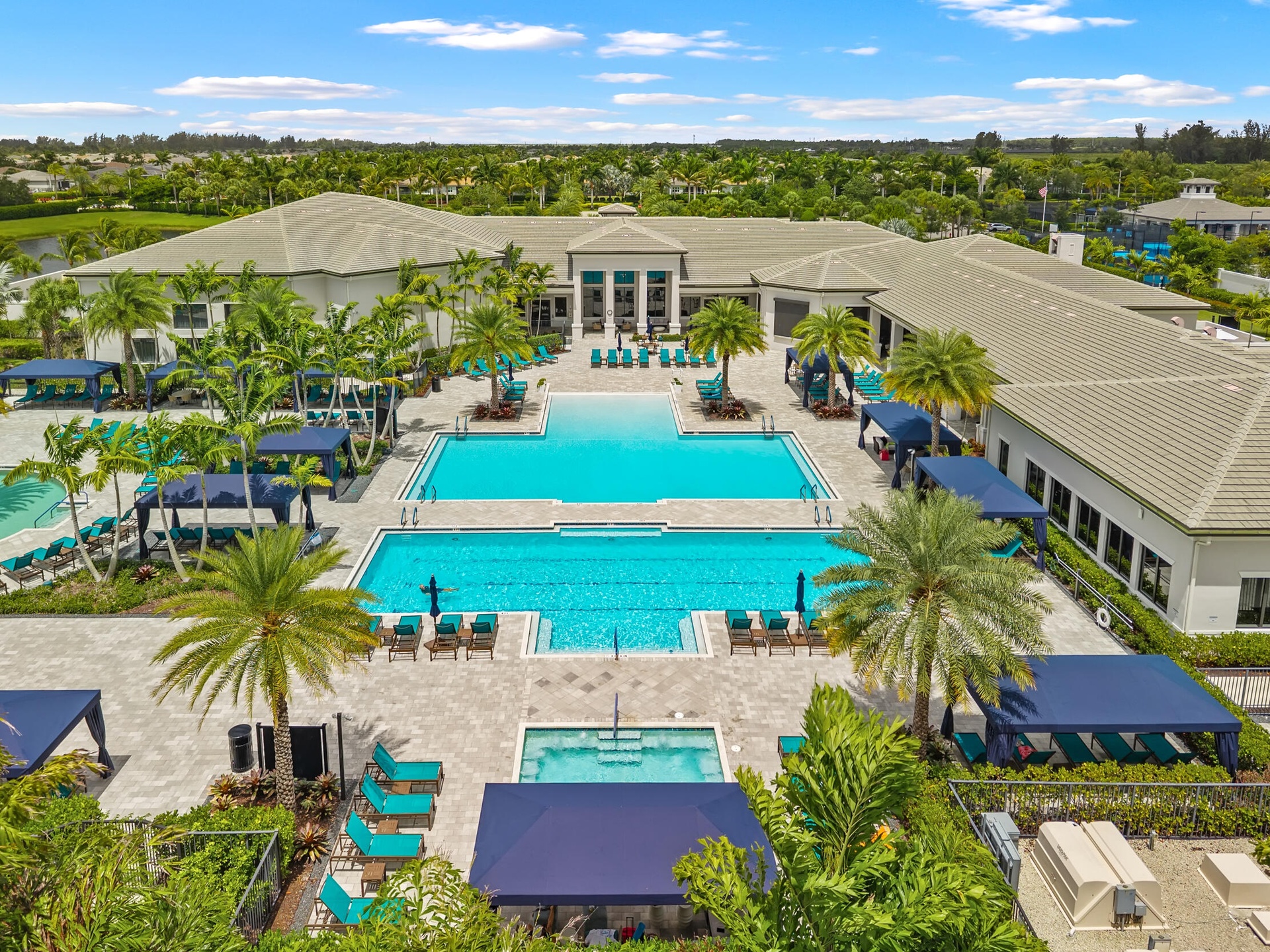 Resort-style pool complex with cabanas and lap pool