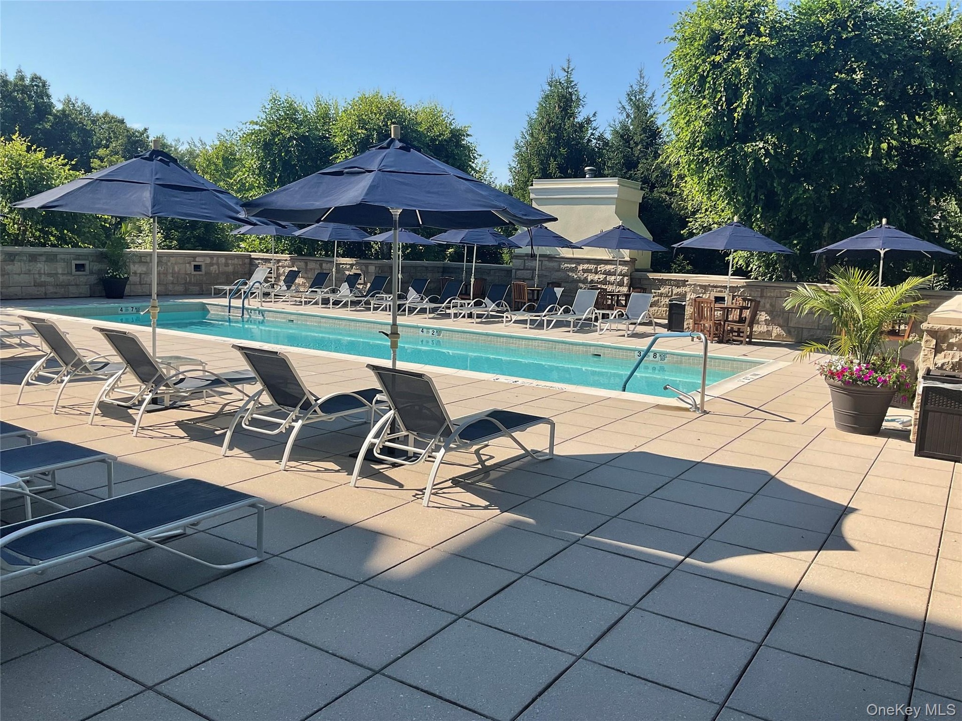 Resort-style living continues outdoors with a secluded pool and spacious sun deck.