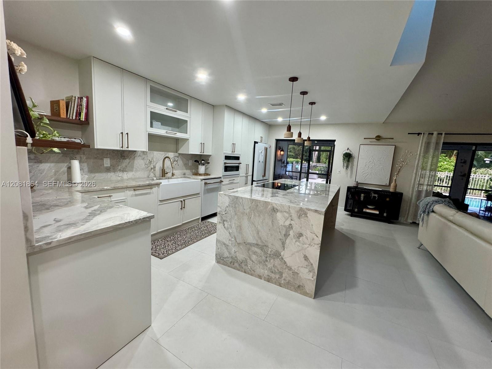 Dining area featuring wood-finish flooring, a wall-mounted floating shelf, and a recessed archway with decorative molding