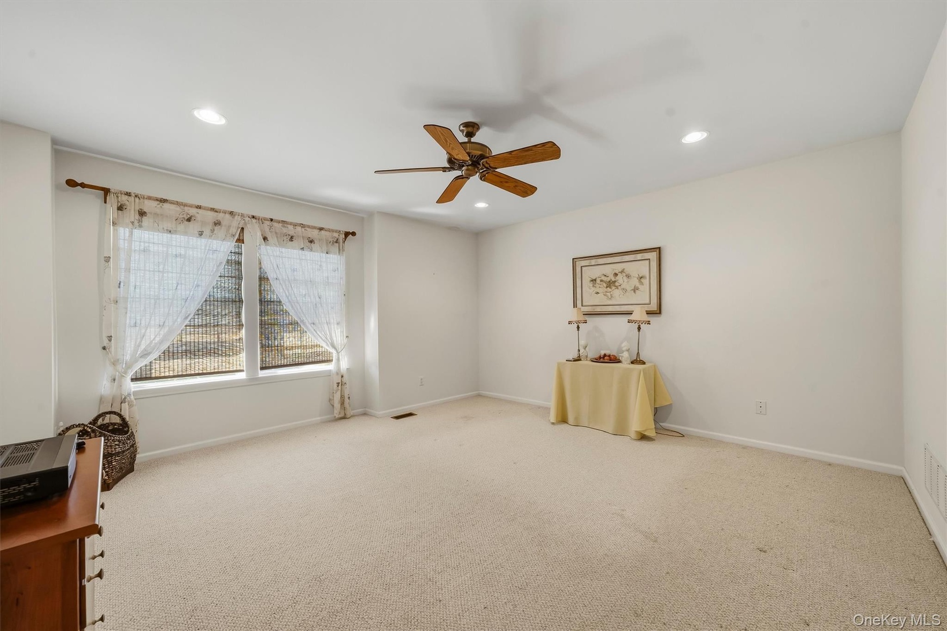 Recessed lighting, ceiling fan, and carpeted flooring
