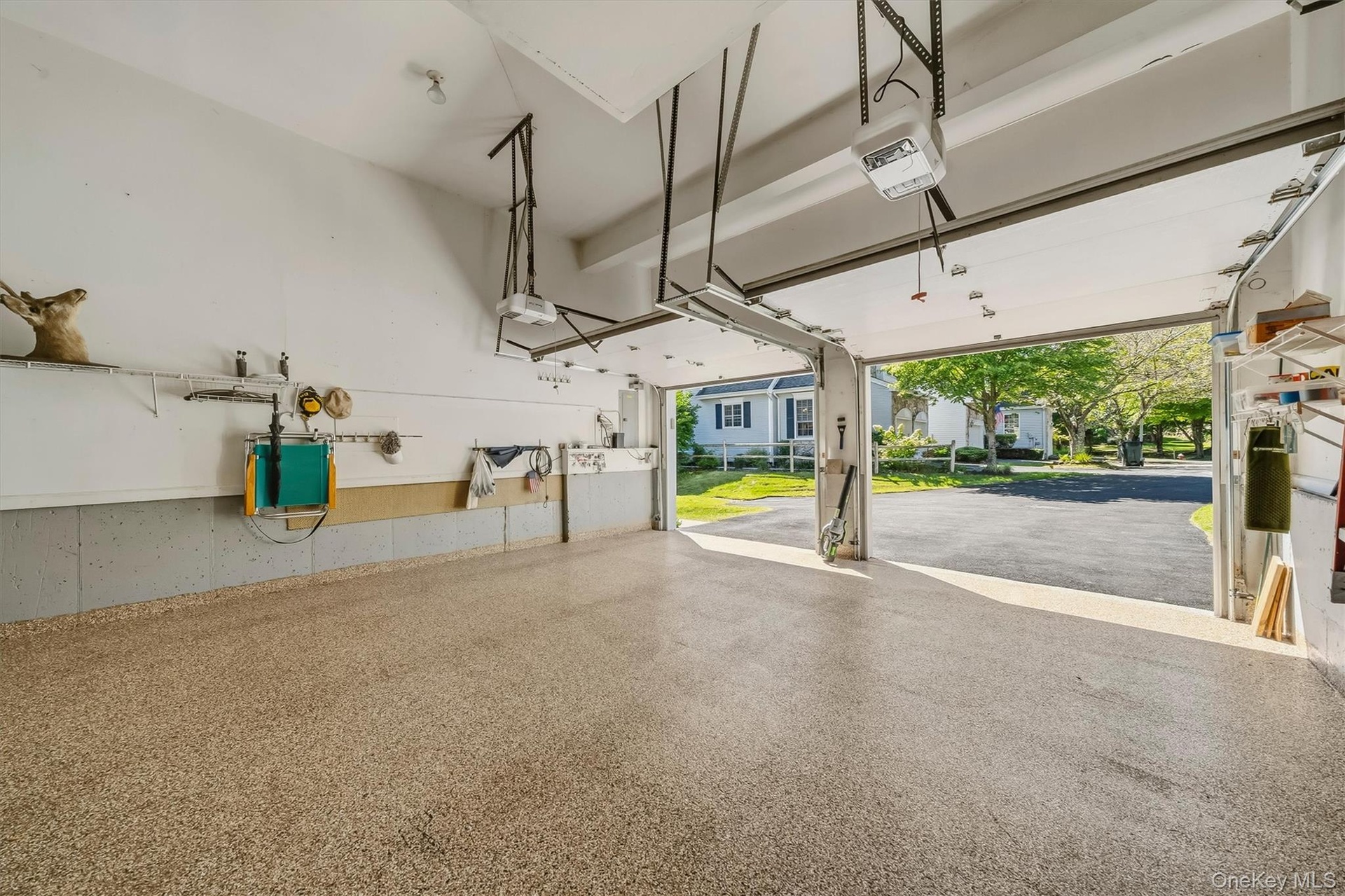 Epoxy-coated concrete flooring, two automatic garage door openers, and built-in shelving
