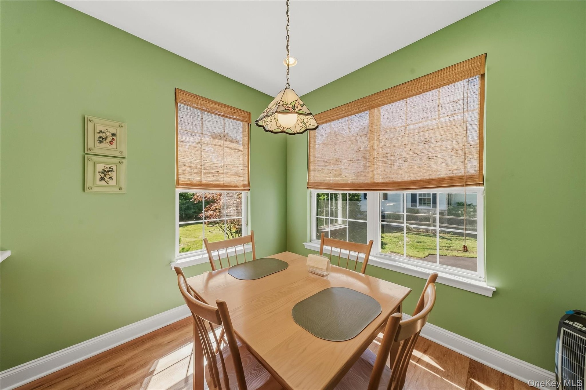 Wood-finish flooring with white trim and baseboards